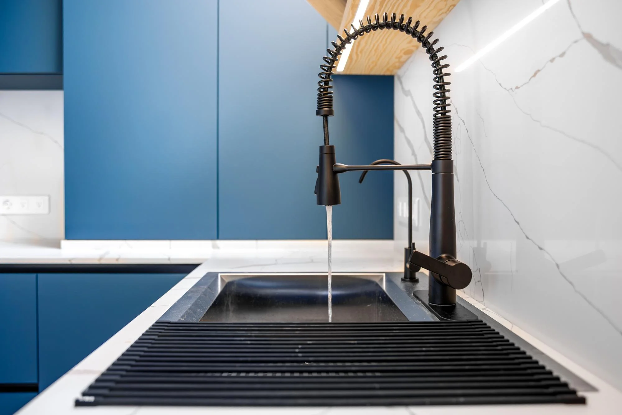 Black workstation sink with tall spring pull down faucet