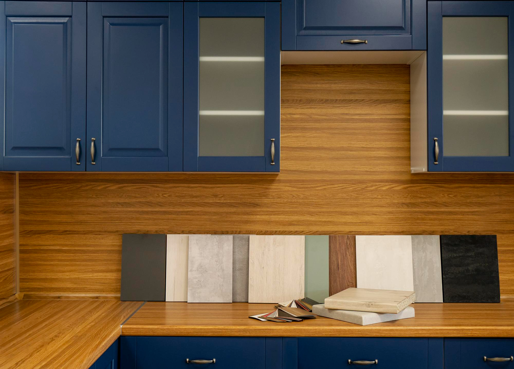 Blue cabinets with wood backsplash and sample panels
