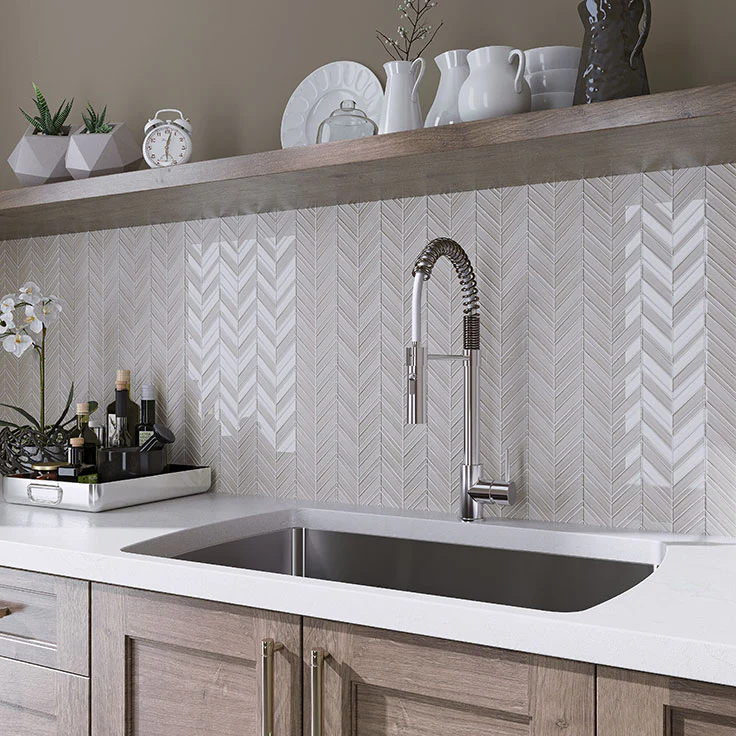 Chevron pattern backsplash in neutral tones above sink