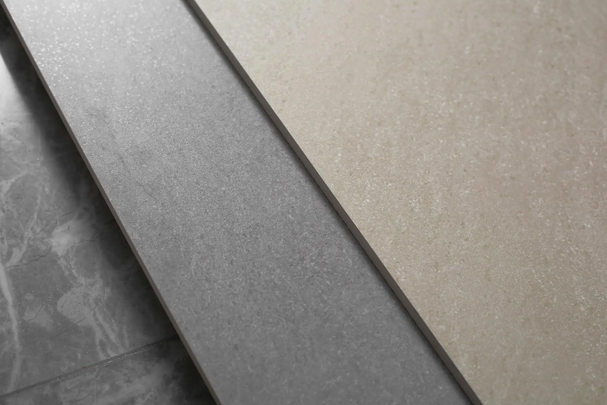 Close up of textured gray and beige stone look tiles