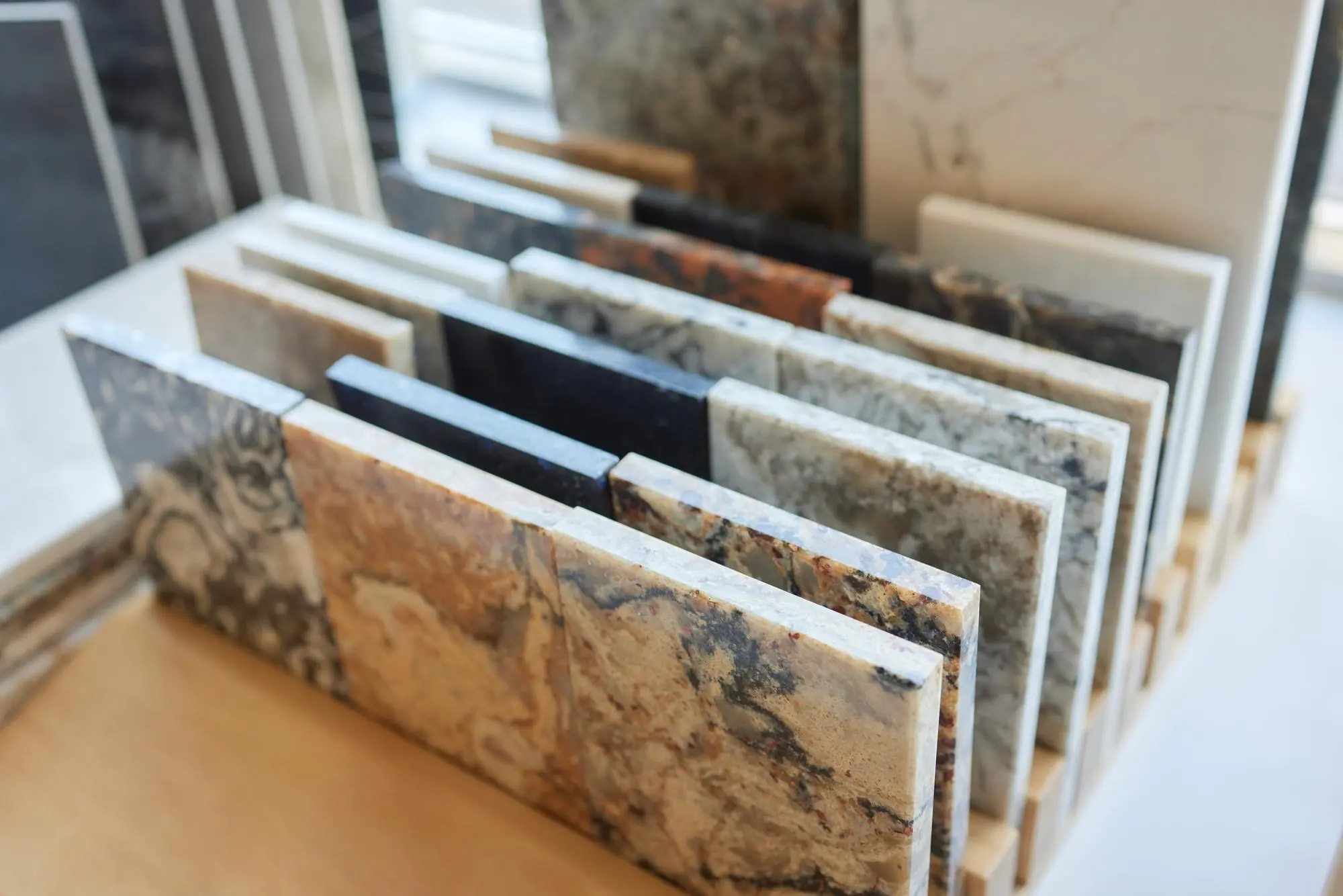 Granite slabs in mixed colors arranged in a showroom rack