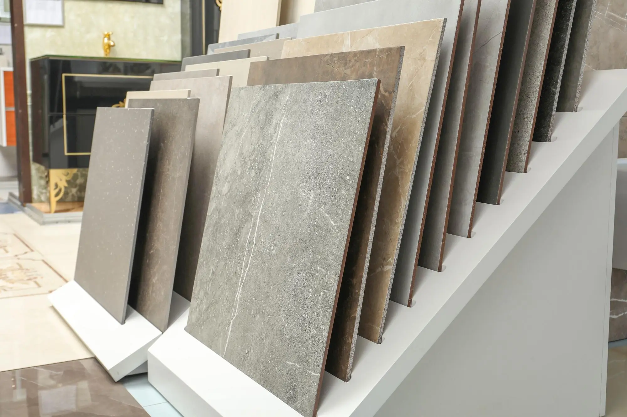 Large stone look tile samples standing in a display rack