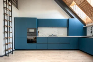 Modern blue L-shaped kitchen under sloped ceiling