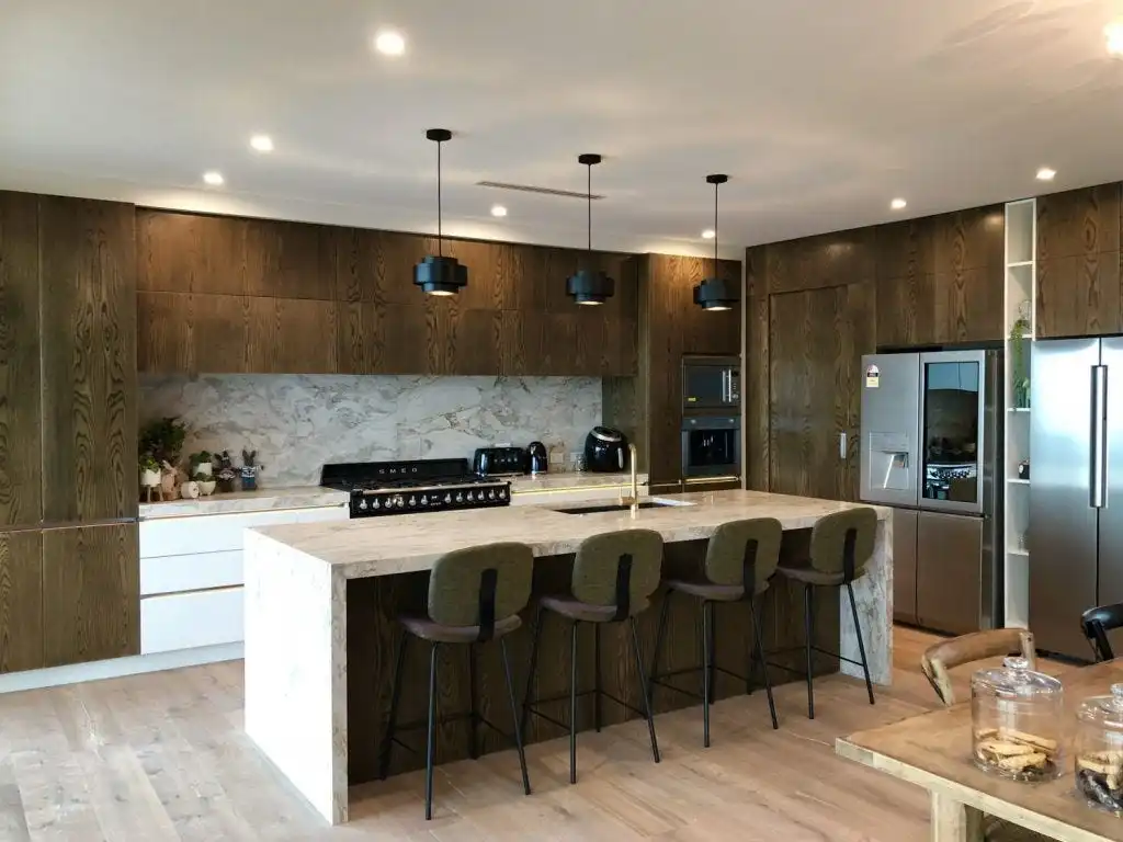 Modern open kitchen with marble island and wood cabinets