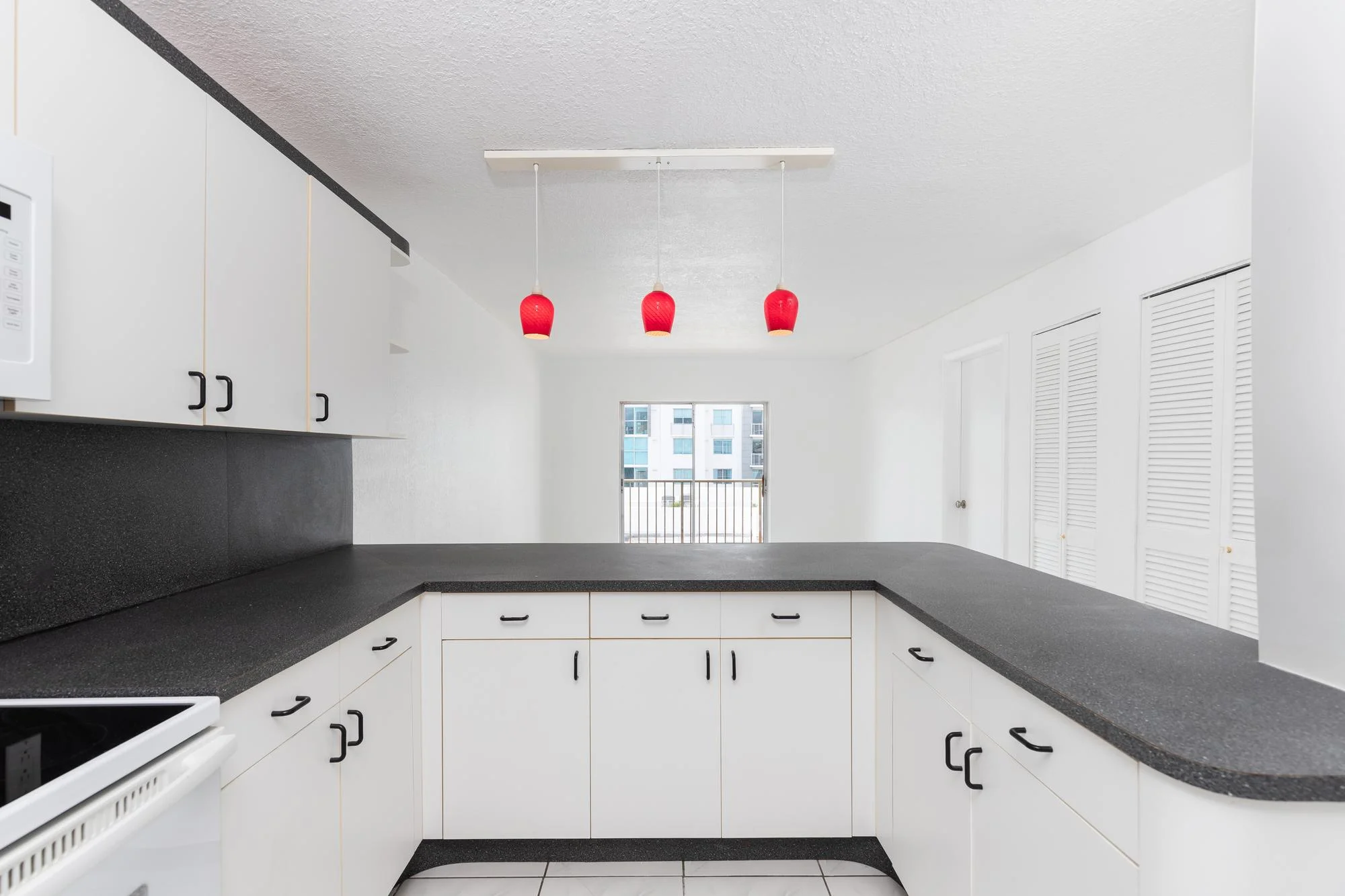 Modern white U Shaped Kitchen Design Ideas with red pendant lights