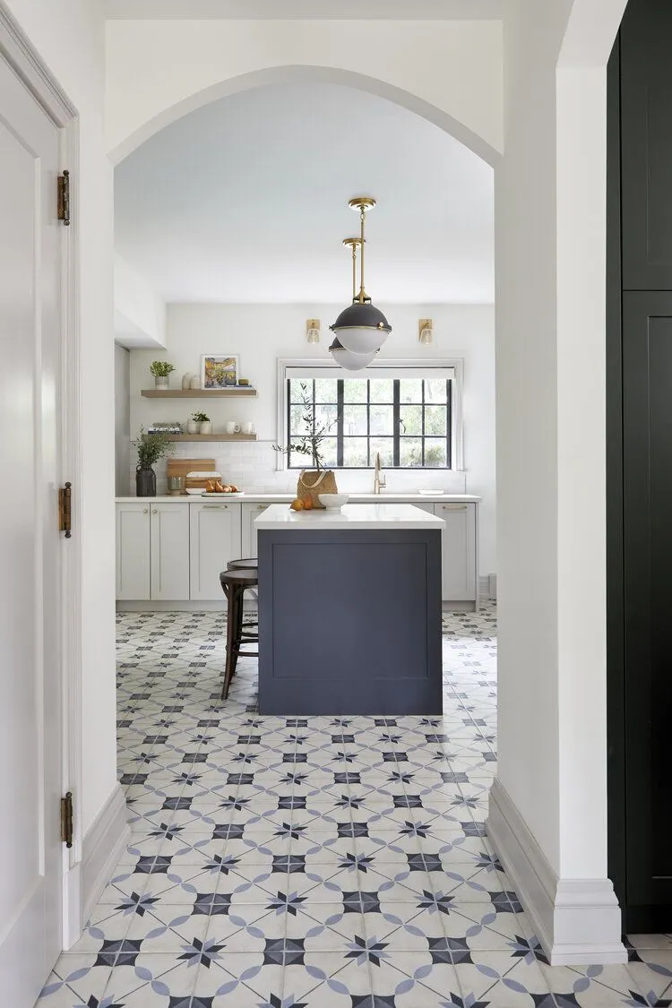 Patterned ceramic tile floor in bright kitchen