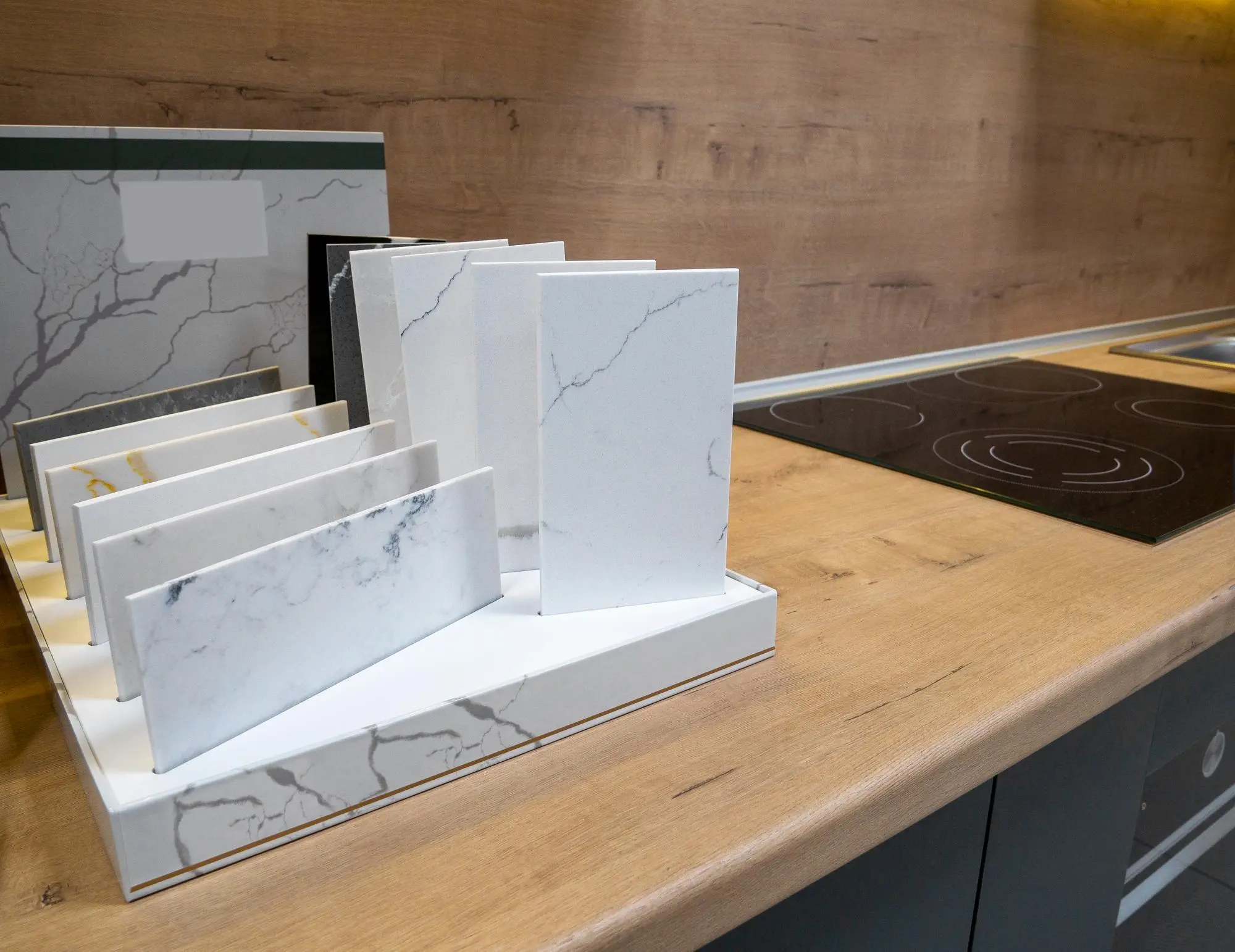 Quartz countertop samples displayed on a wooden surface