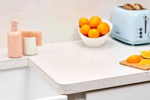 White speckled laminate countertop with toaster and oranges