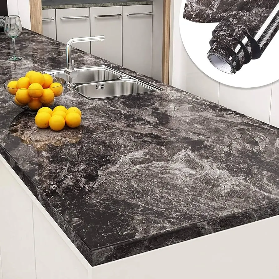 Black marble contact paper applied to kitchen counter surface