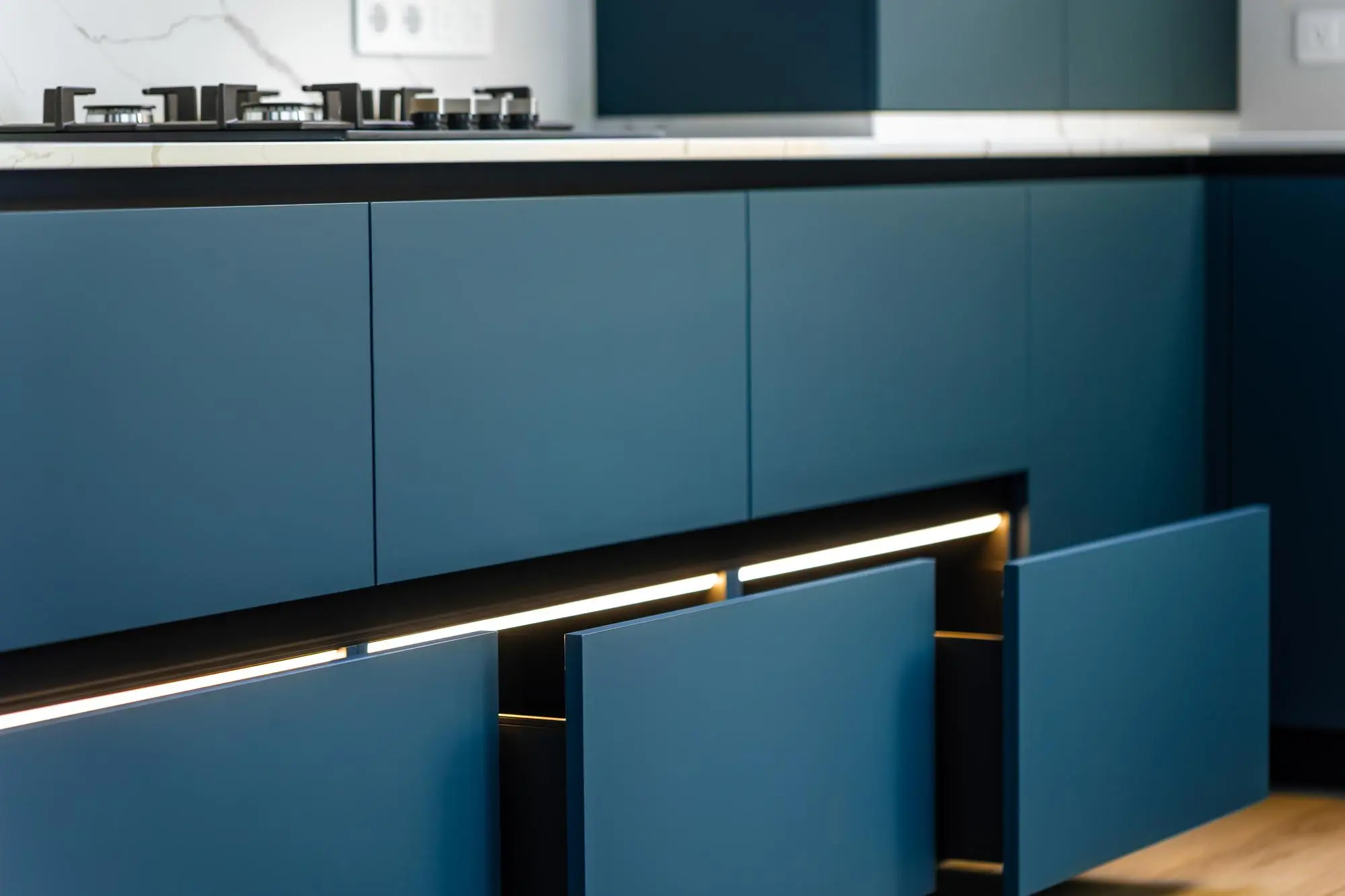 Blue modern kitchen cabinets with soft under cabinet lighting Blue modern kitchen cabinets with soft under cabinet lighting