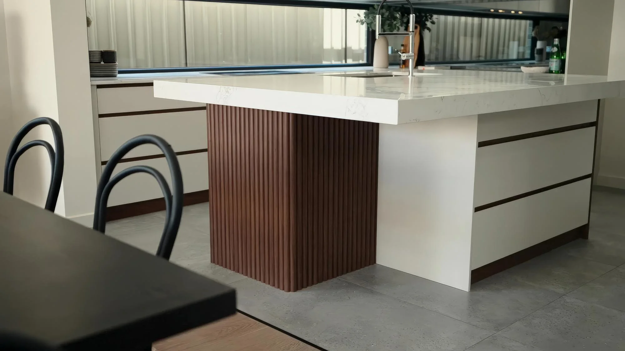 Contemporary kitchen peninsula with waterfall countertop