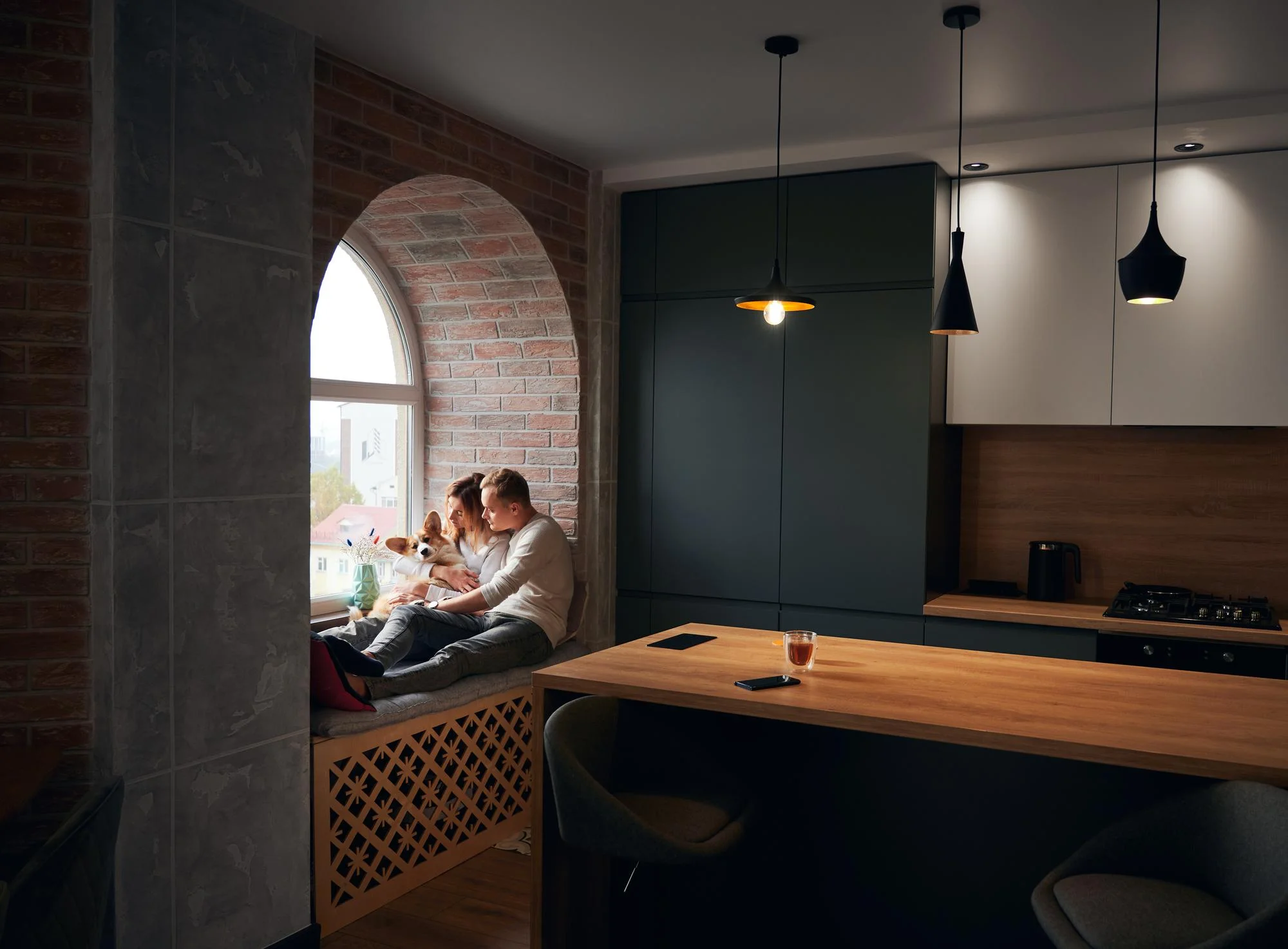 Modern kitchen with pendant lighting and cozy window seating