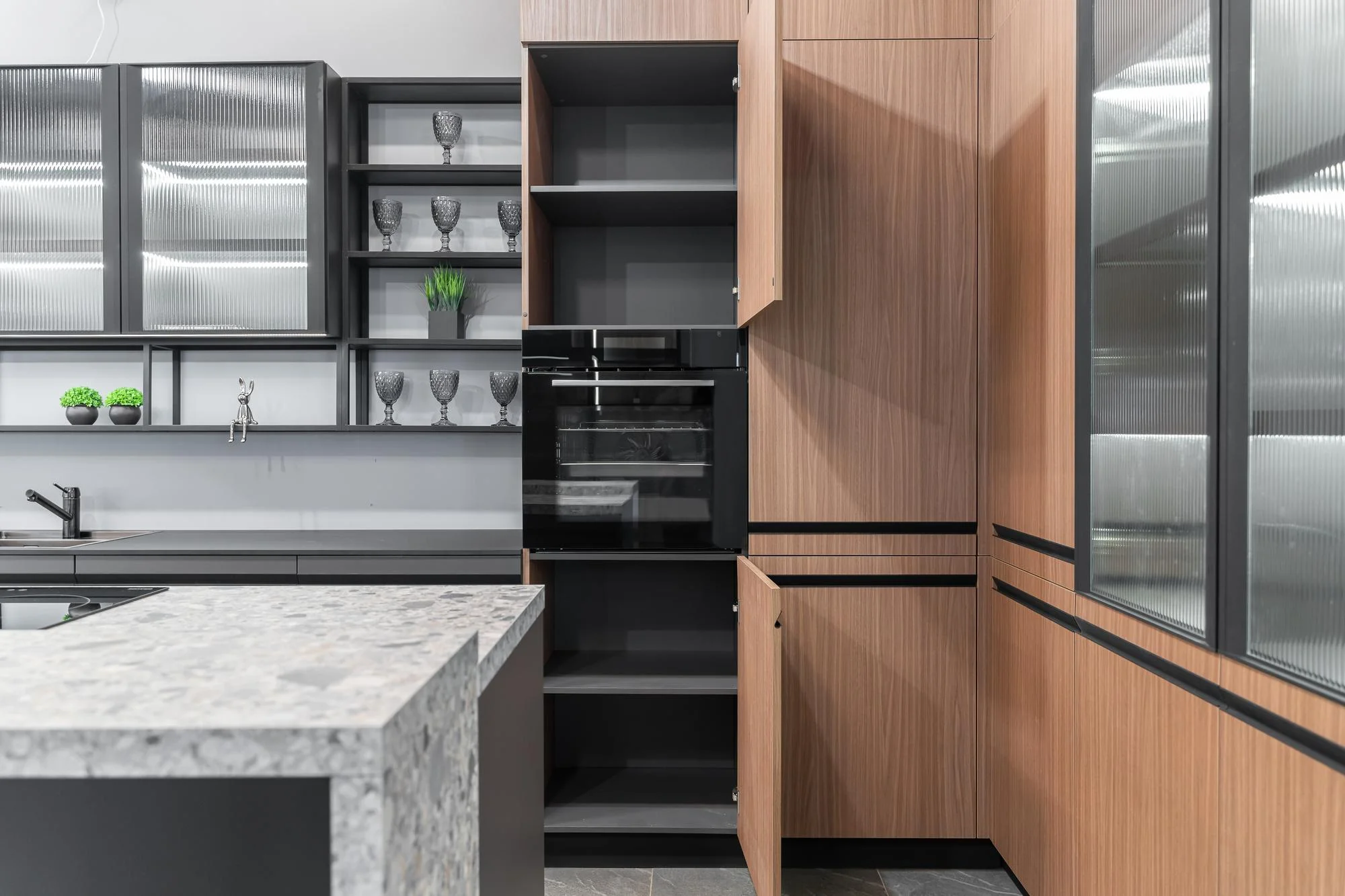 Open cabinet showing shelves in a modern wood kitchen