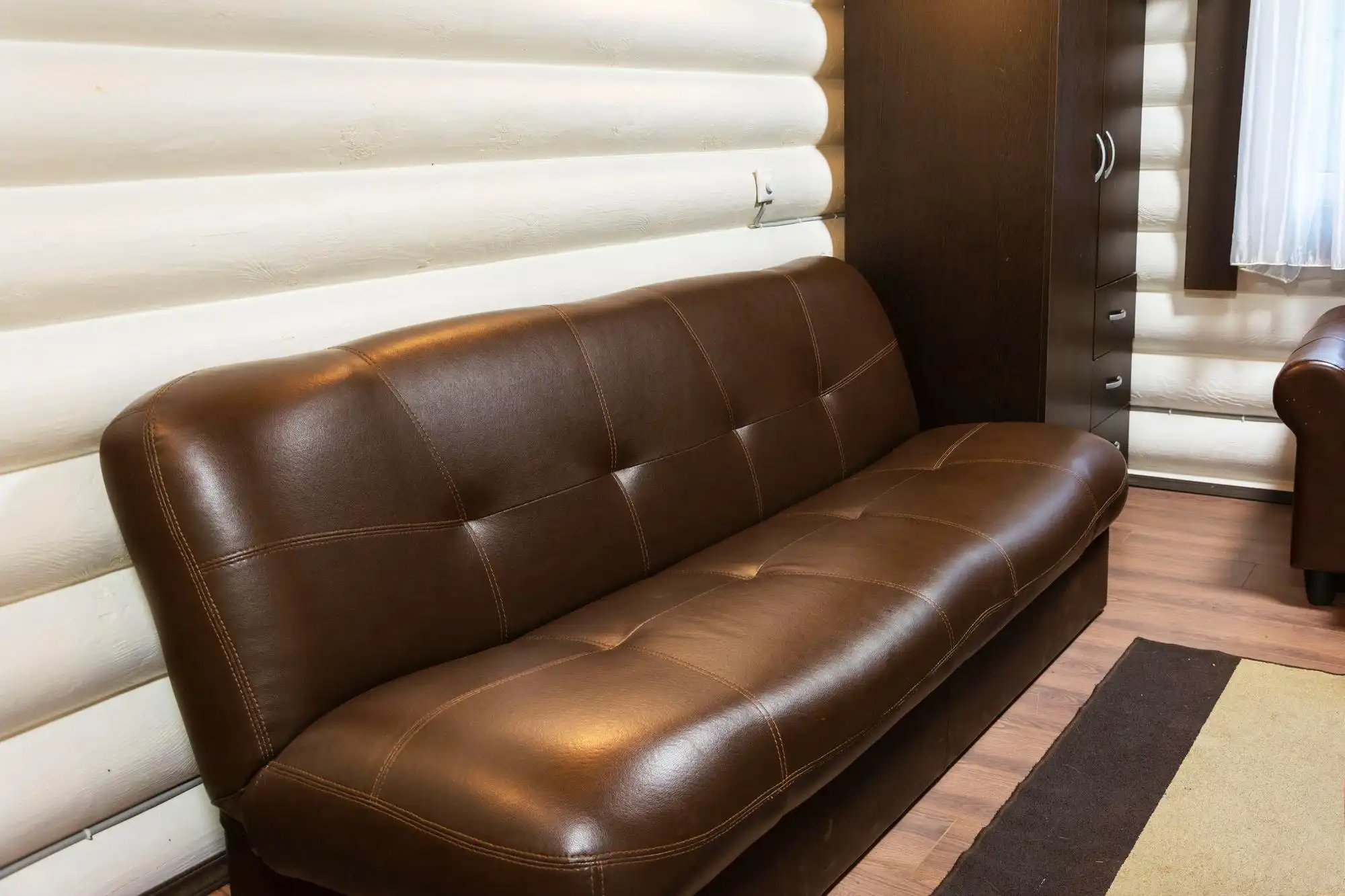 Brown leather sofa in warm rustic living room
