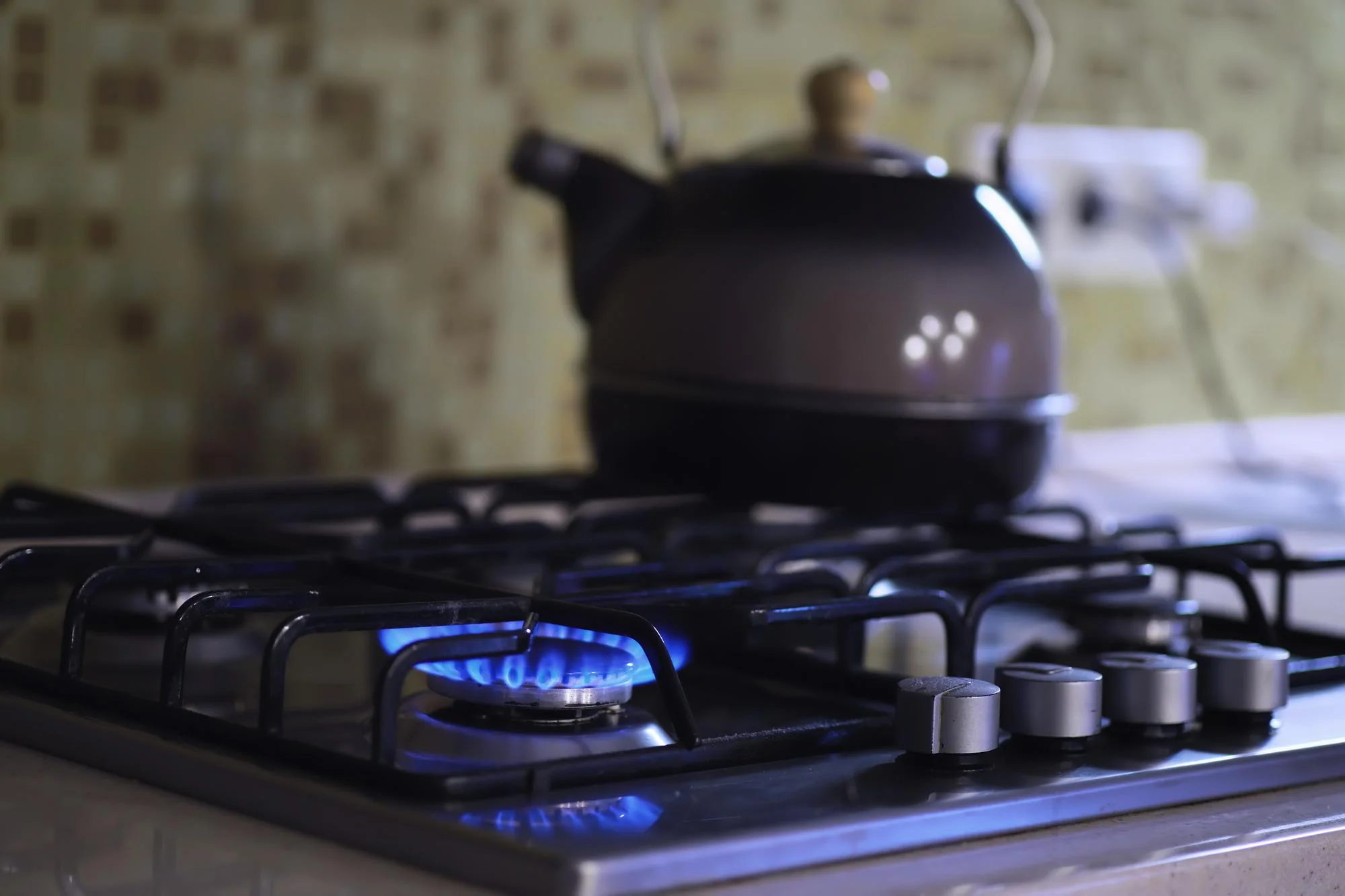 Chef cooking on gas stove with open flame