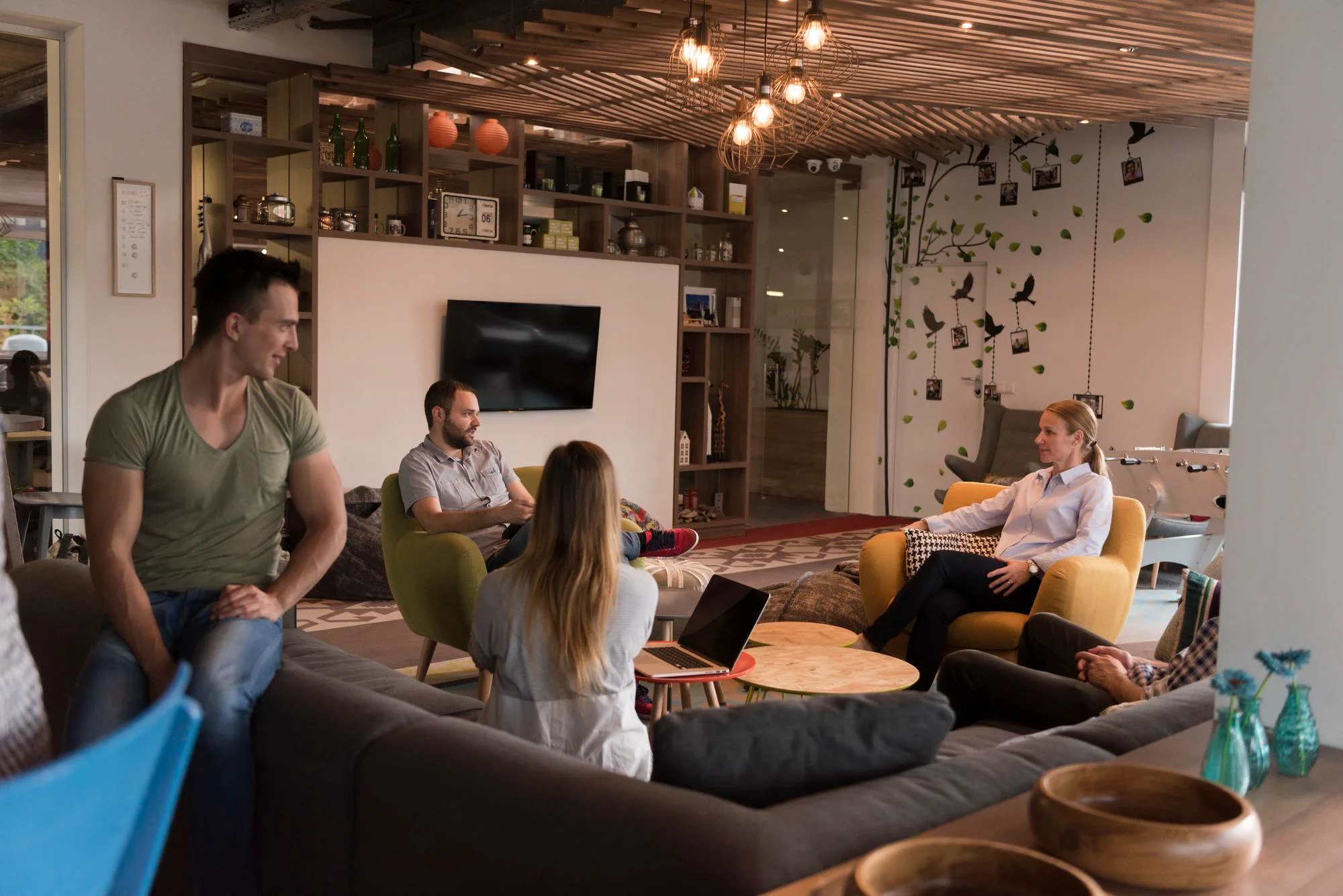 Cozy modern lounge with people chatting and warm lighting