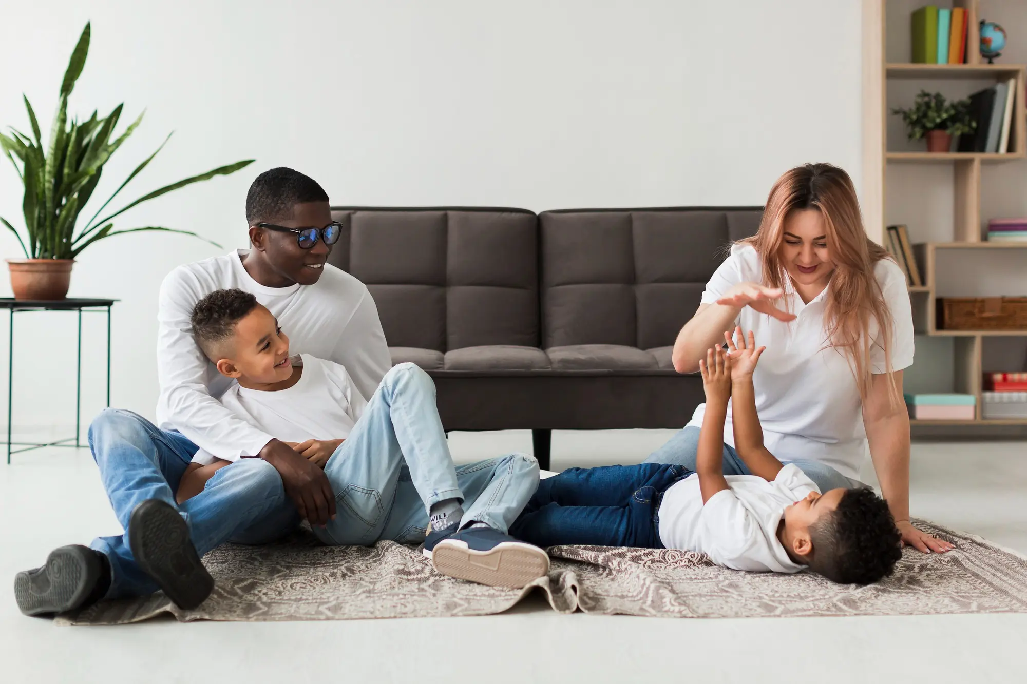 Family playing and relaxing together on living room floor