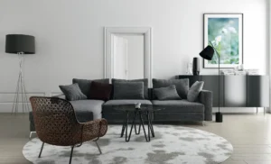 Gray sectional with round rug and black modern decor