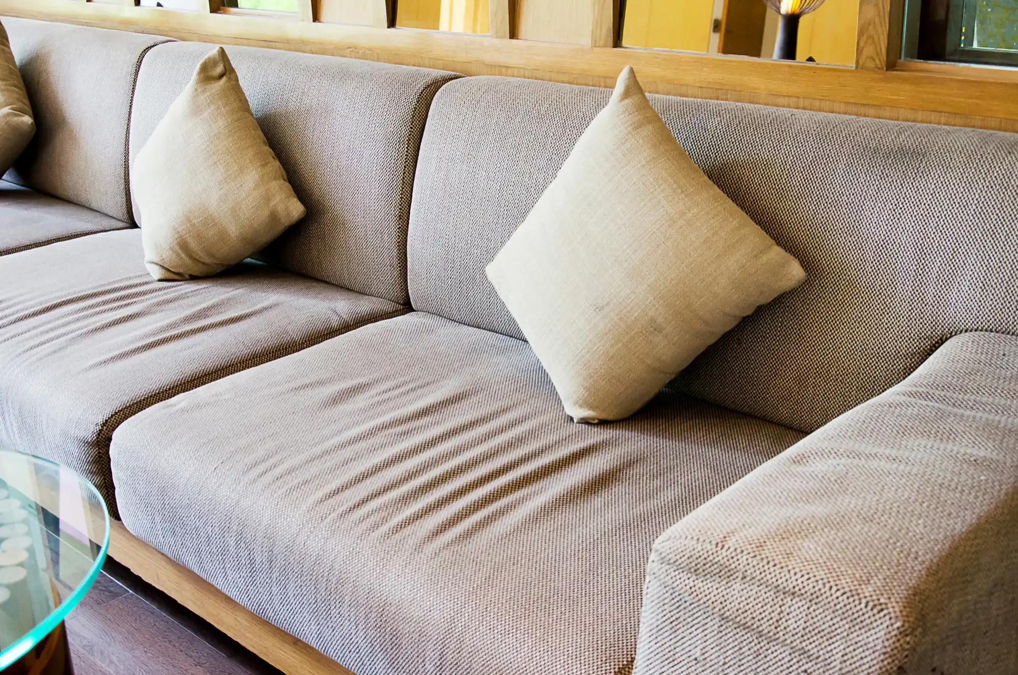 Grey fabric sofa with neutral cushions in living room