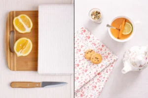 Kitchen and tea towels flat lay with lemons, tea cup and cookies