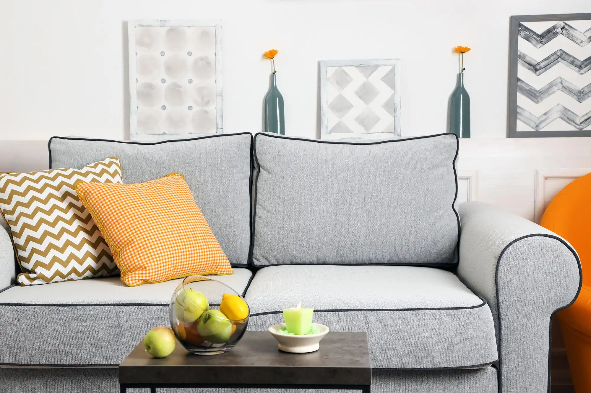 Light gray sofa with yellow patterned throw pillows