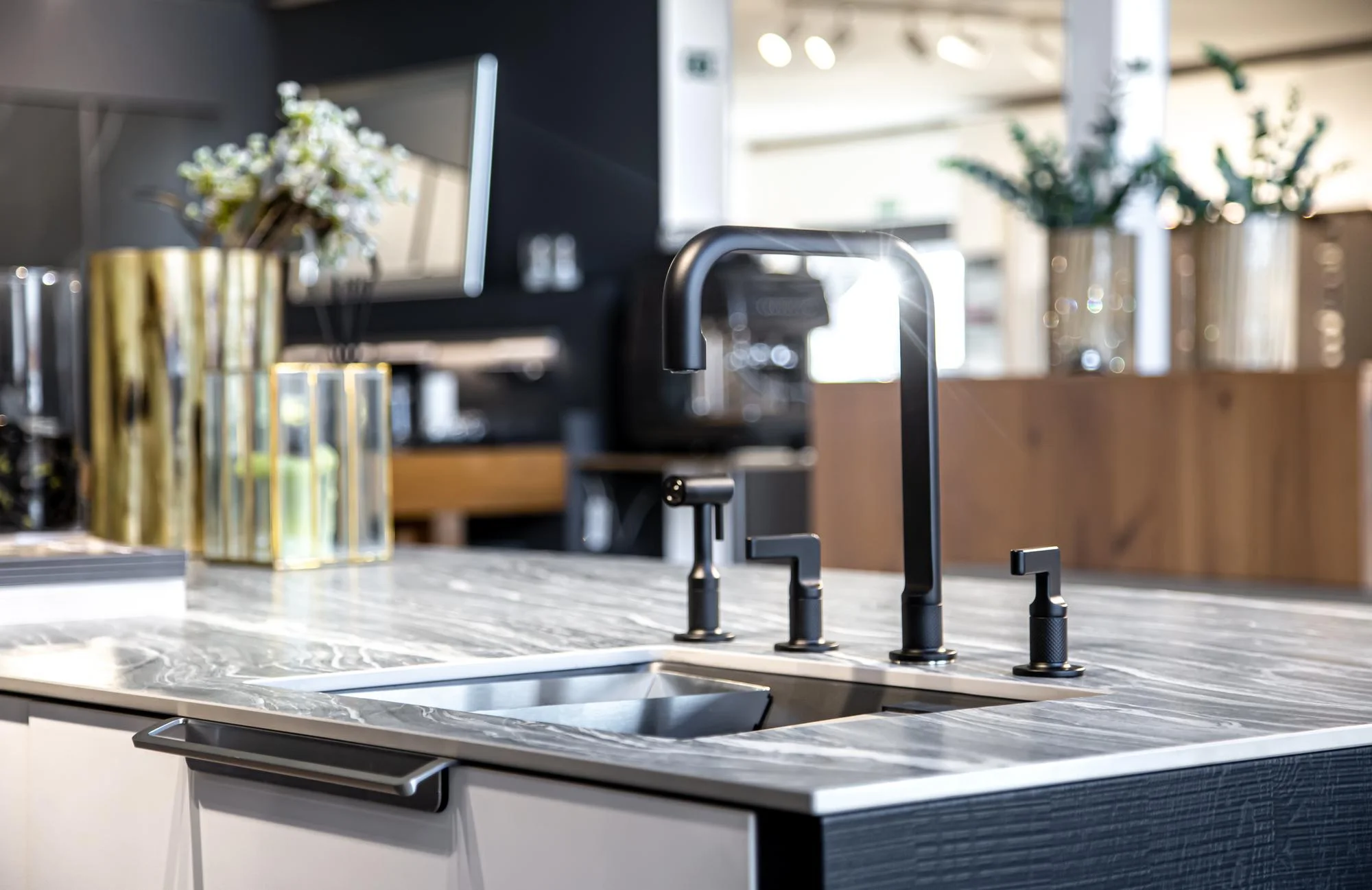 Stylish black faucet on marble kitchen countertop