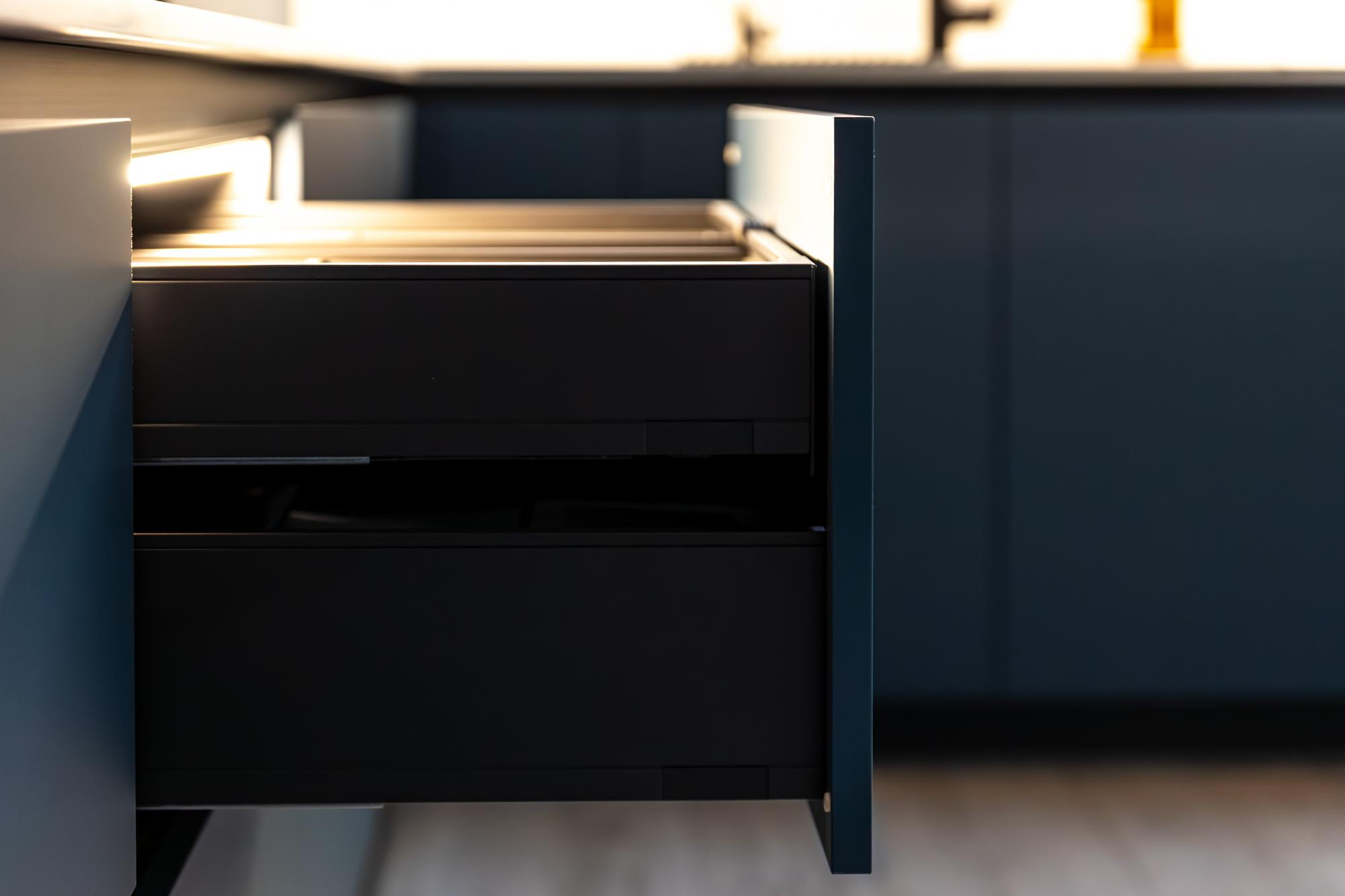 Dark kitchen cabinets with open drawer detail