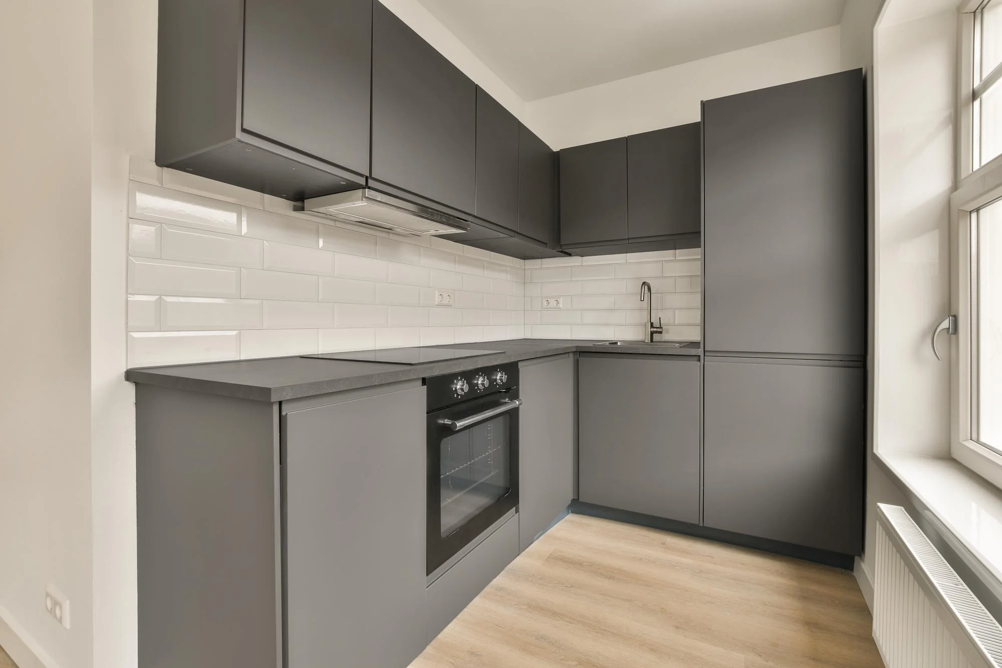 Modern grey kitchen with white tile backsplash and cabinets Modern grey kitchen with white tile backsplash and cabinets
