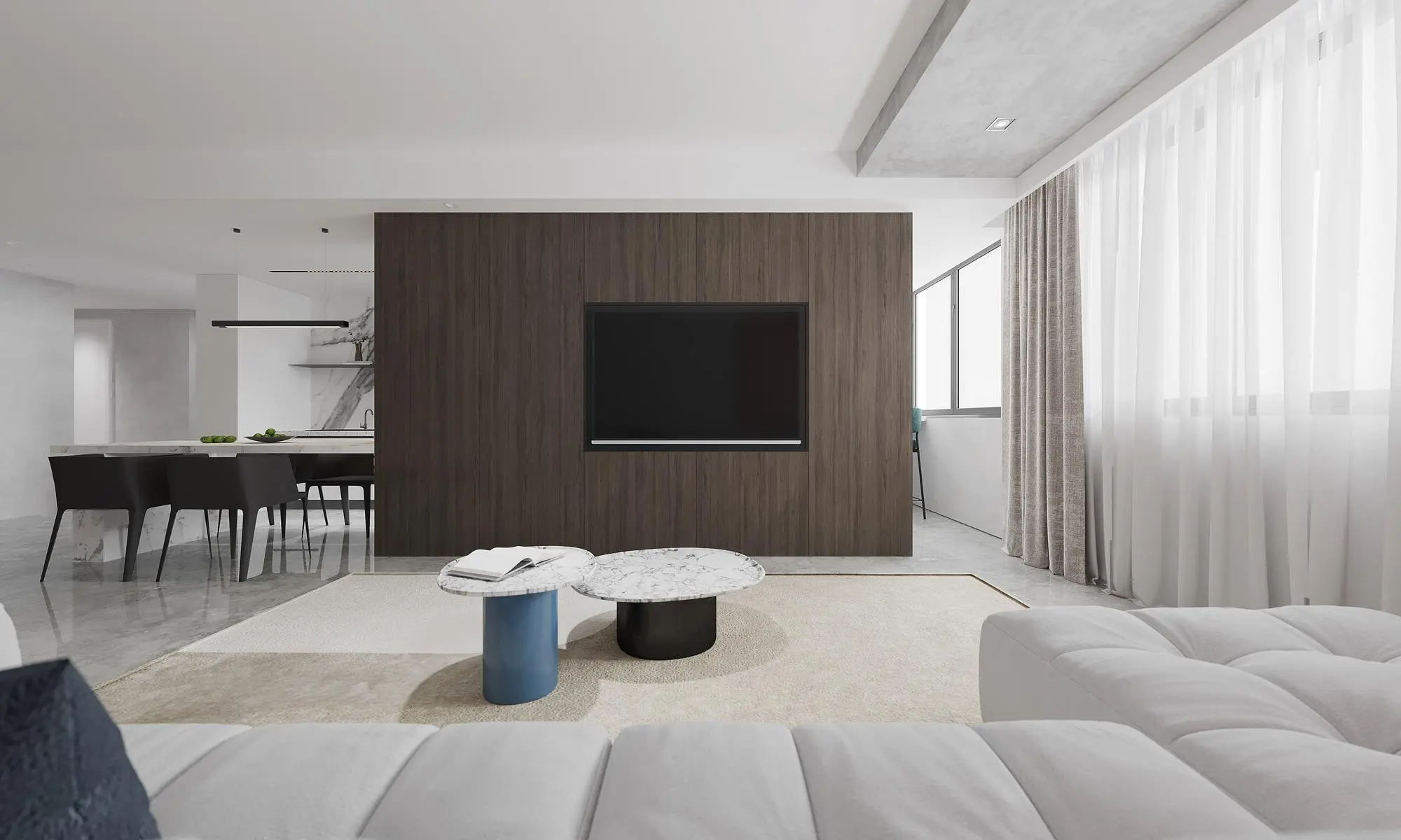 Sala de estar moderna con cortinas transparentes y luz natural.