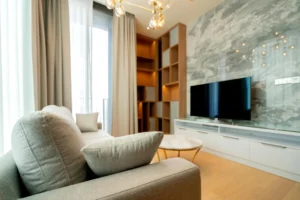 Modern living room with sofa and TV on marble accent wall
