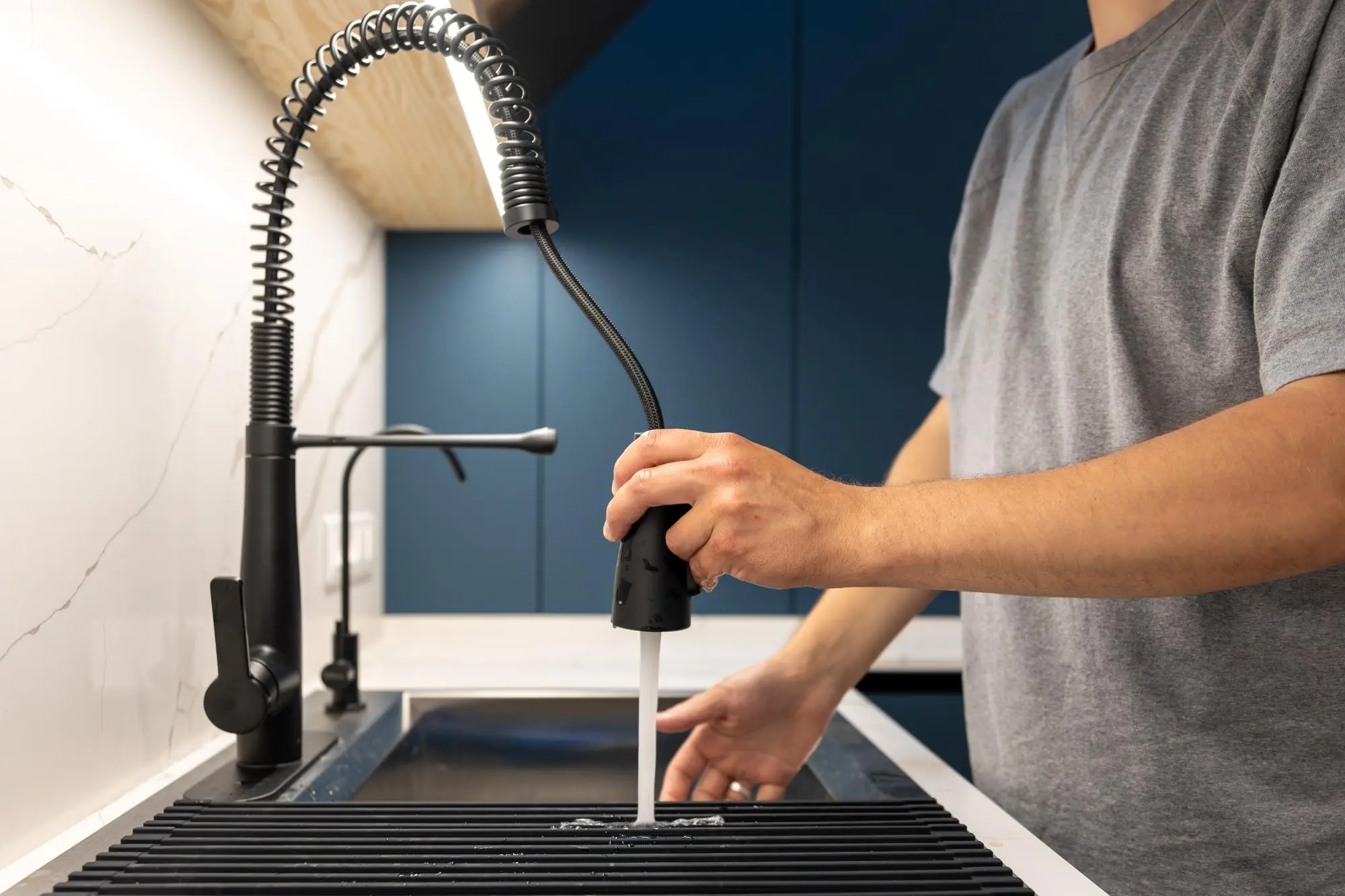 Pull out kitchen faucet in use over sink