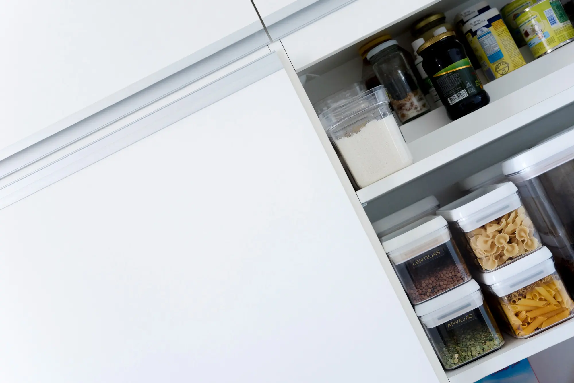 Pull out pantry cabinet with organized food containers