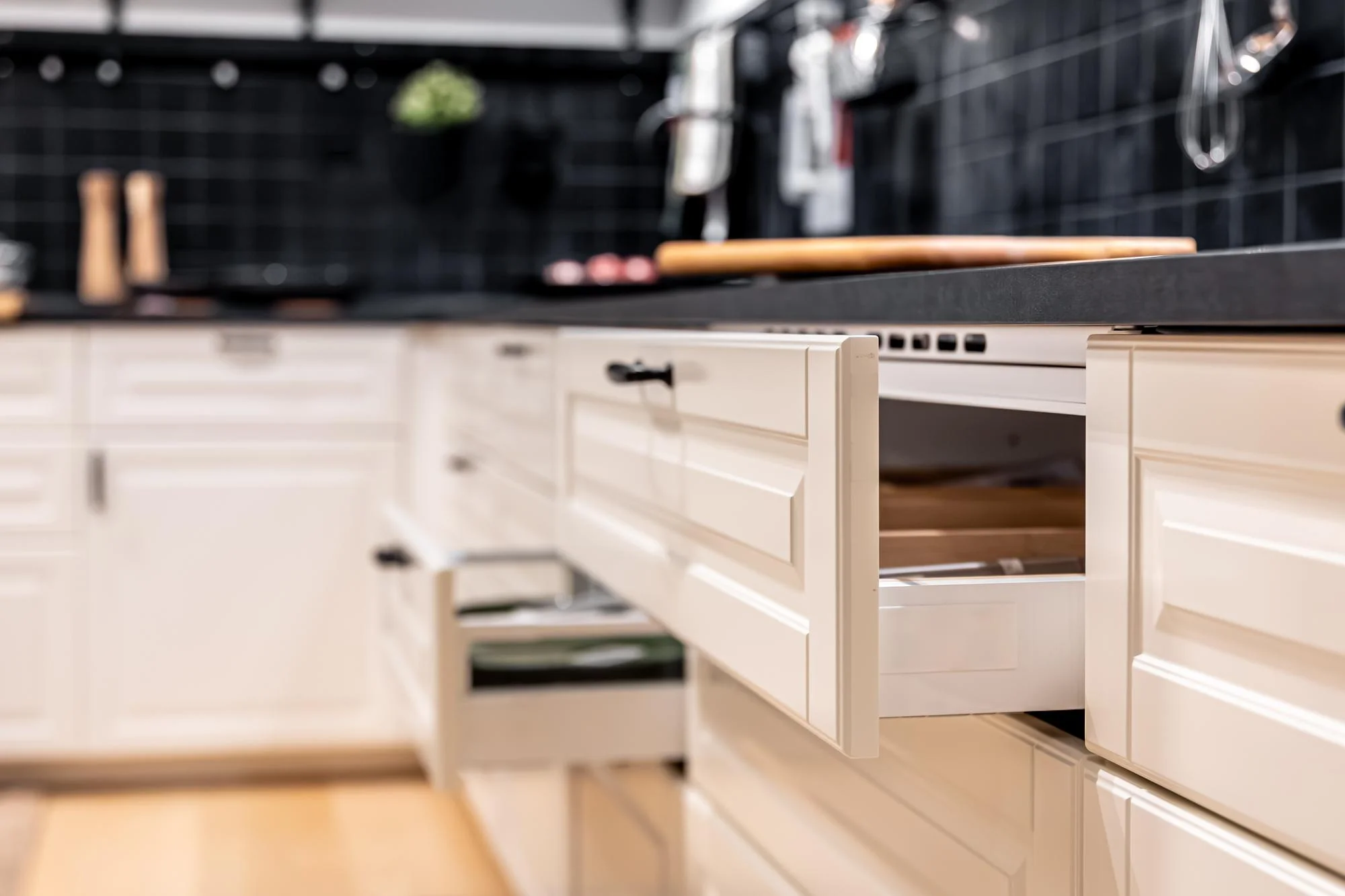 White kitchen cabinets with open drawer close up