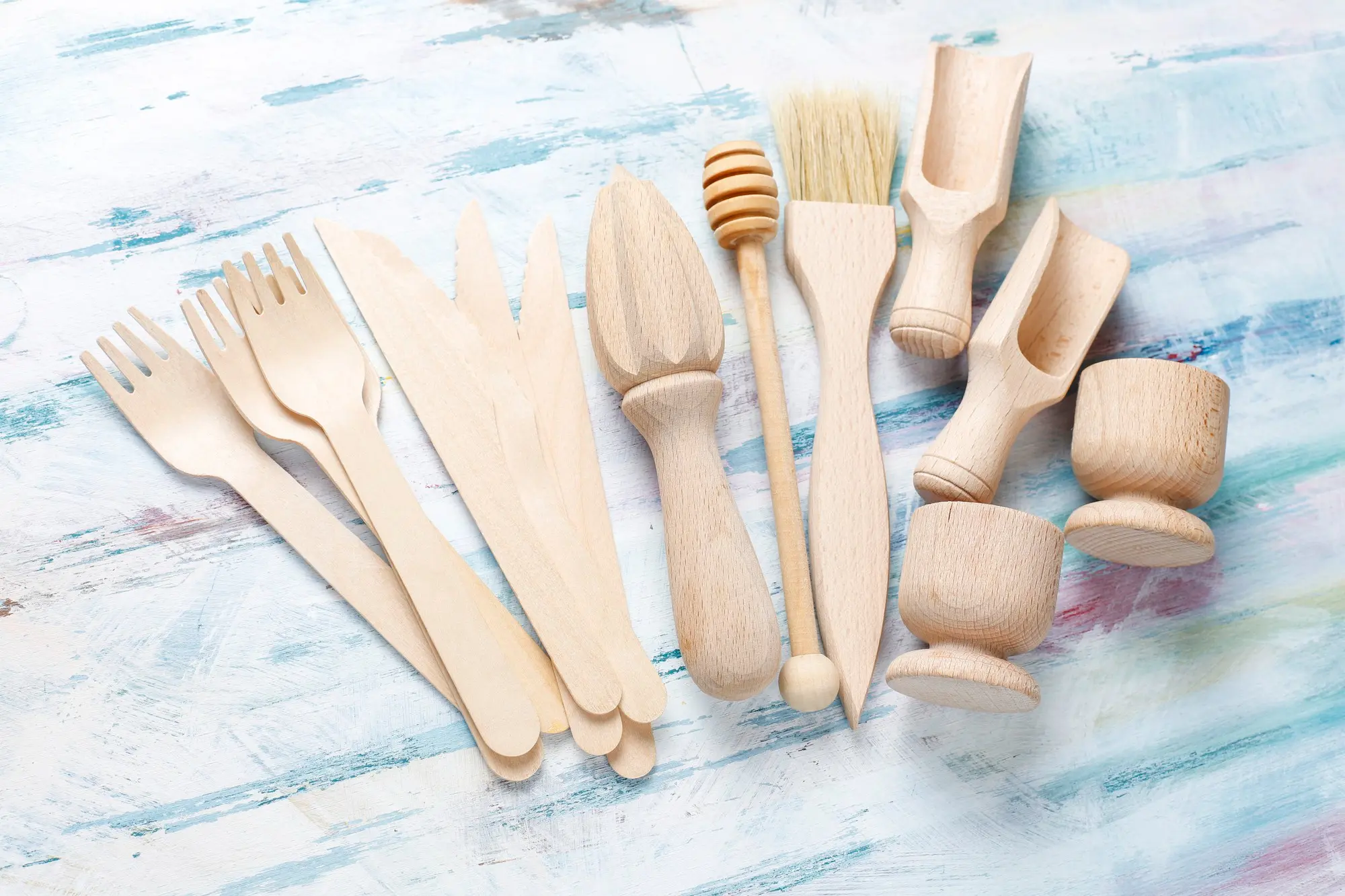 Bamboo kitchen tools set on colorful textured surface