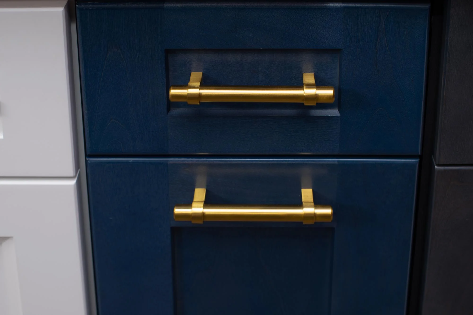 Blue cabinet drawers with gold bar handles