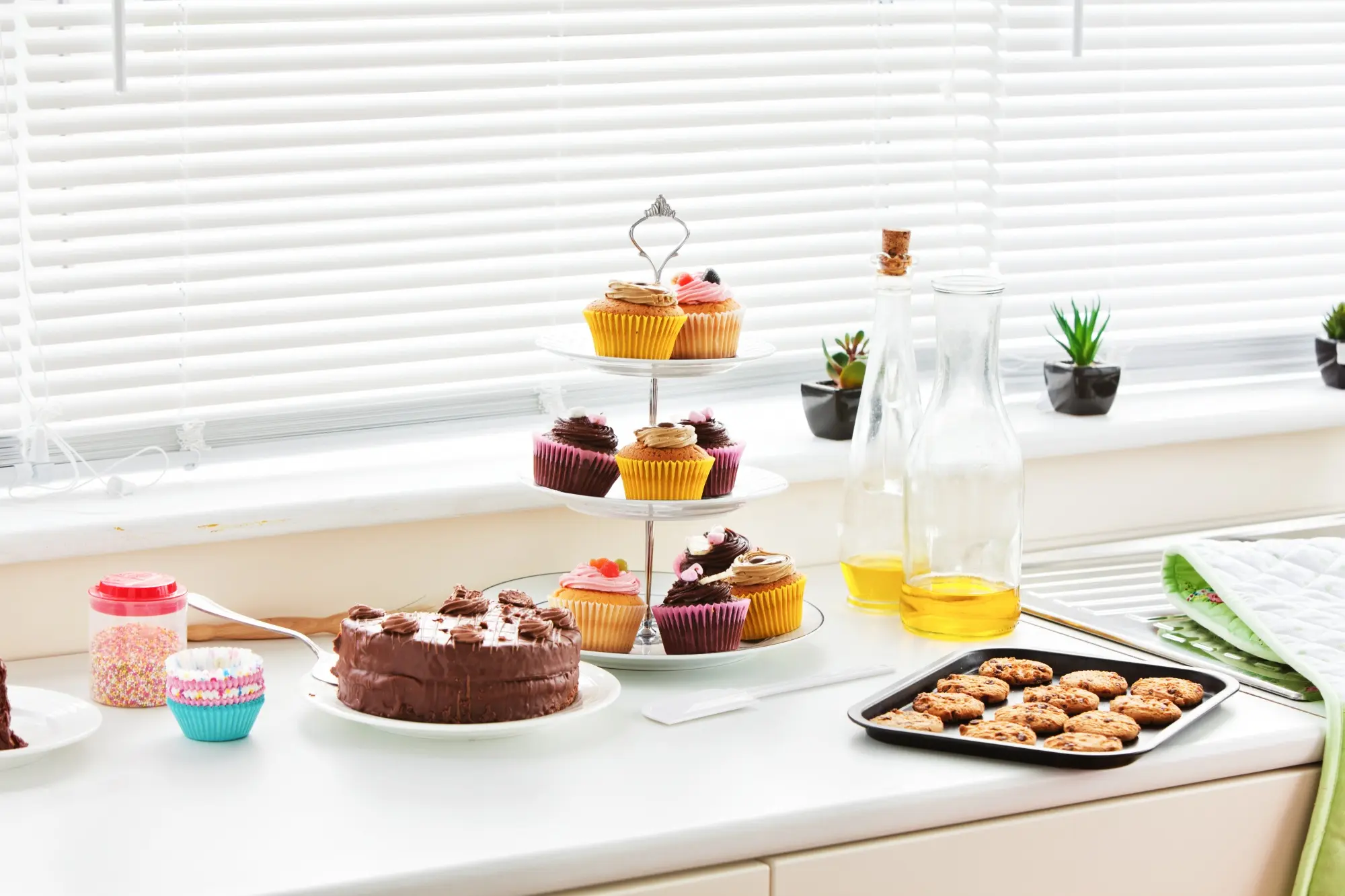 Cupcakes and desserts displayed on bright kitchen counter
