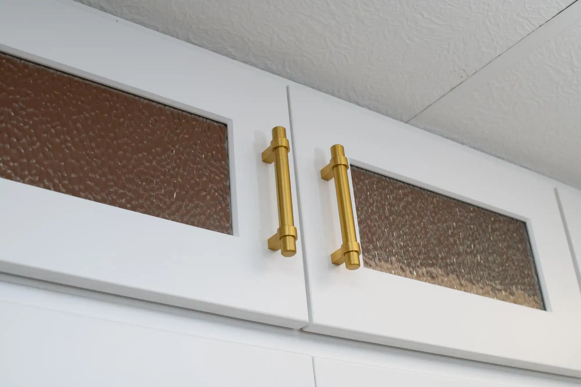 Gold cabinet handles on white kitchen doors