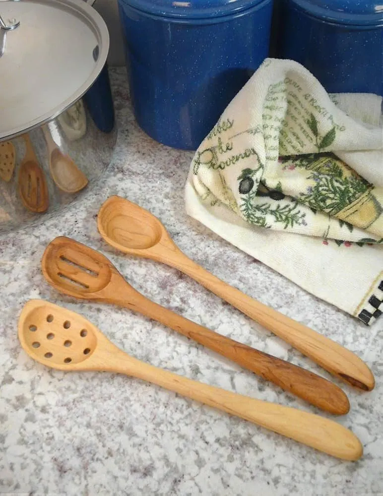 Maple wood cooking utensils set on kitchen countertop