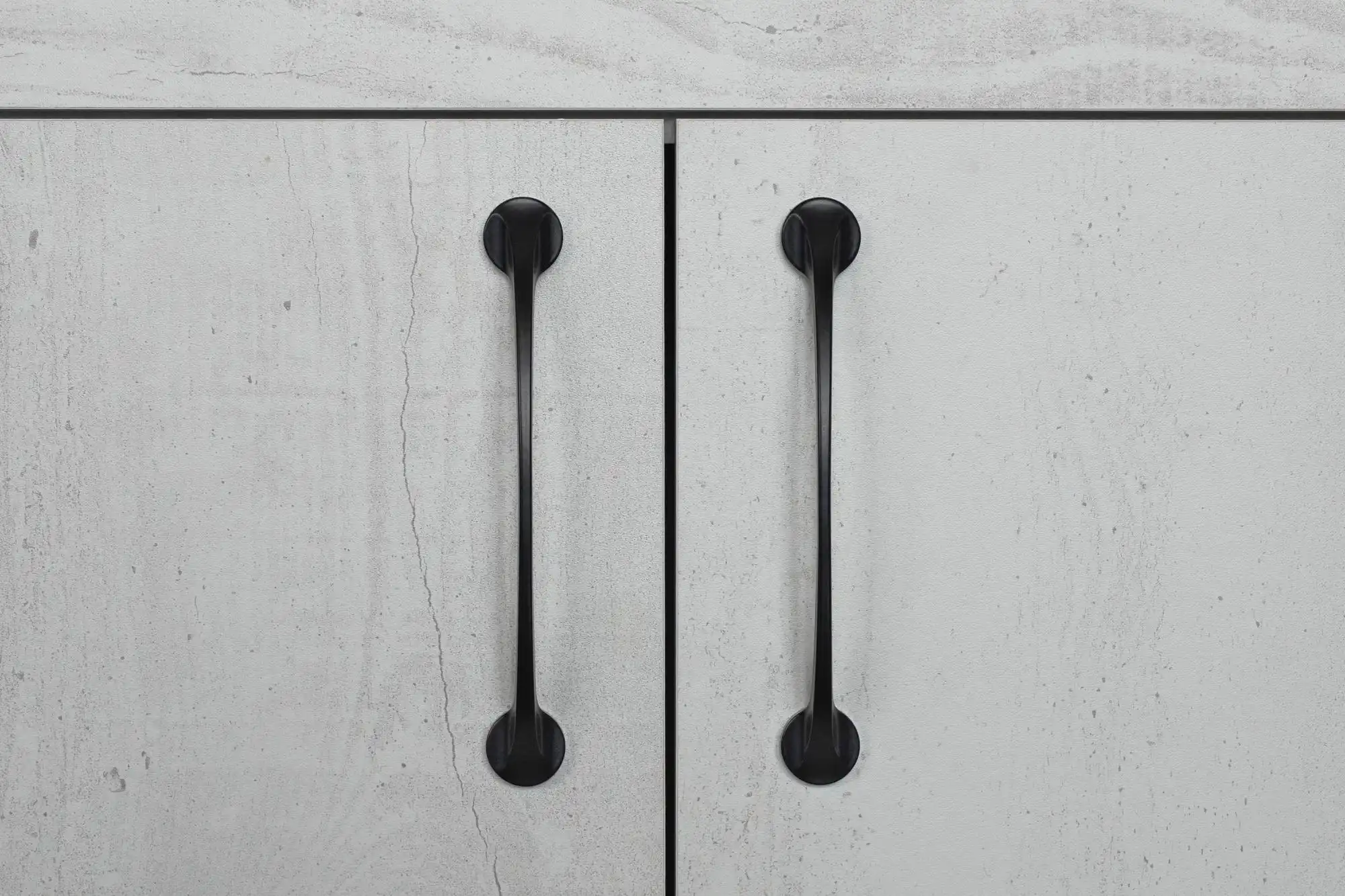 Matte black cabinet handles on modern drawers