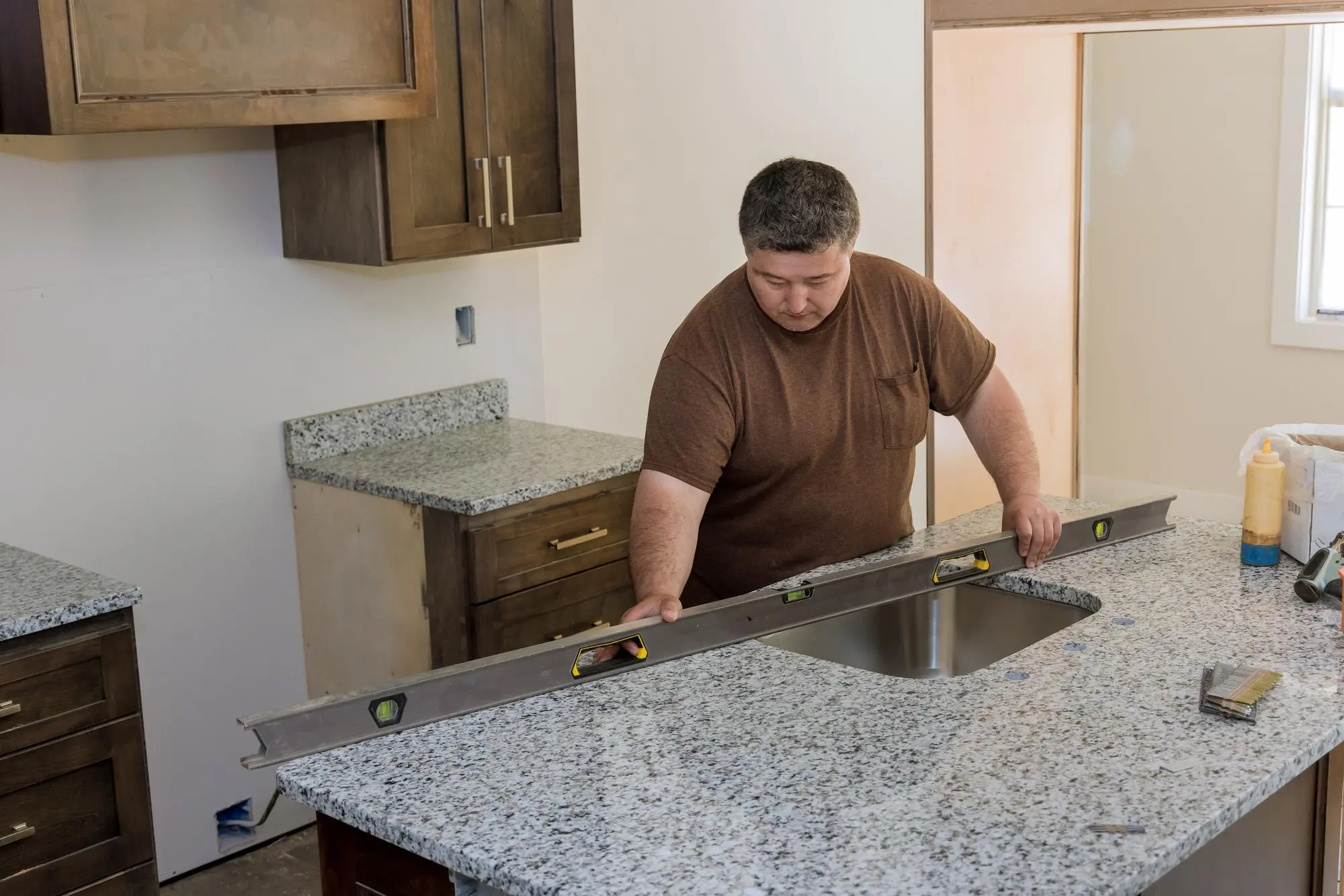 Measuring kitchen island countertop during installation
