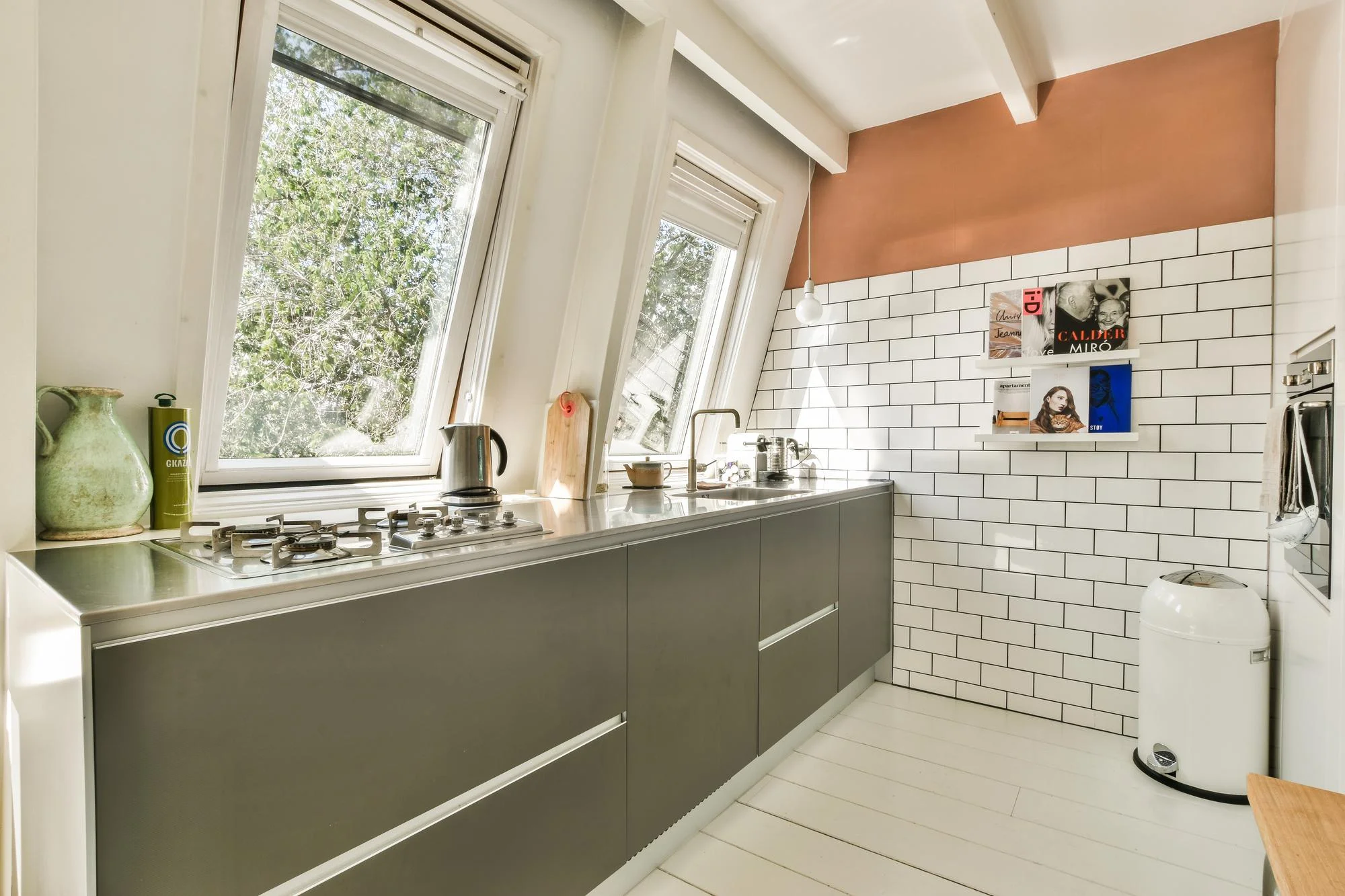 Modern galley kitchen with window and sleek cabinets