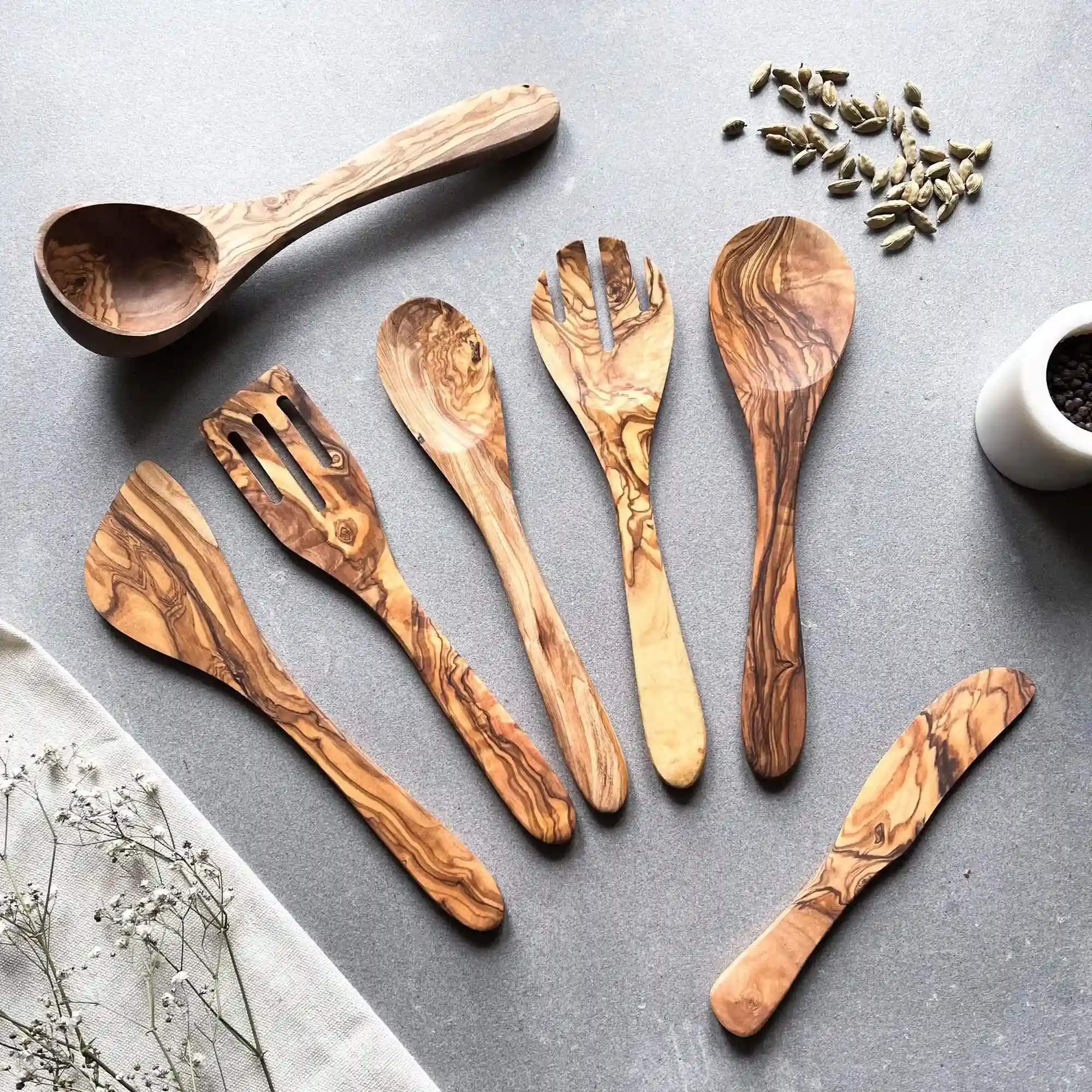 Olive wood kitchen utensils with natural grain patterns