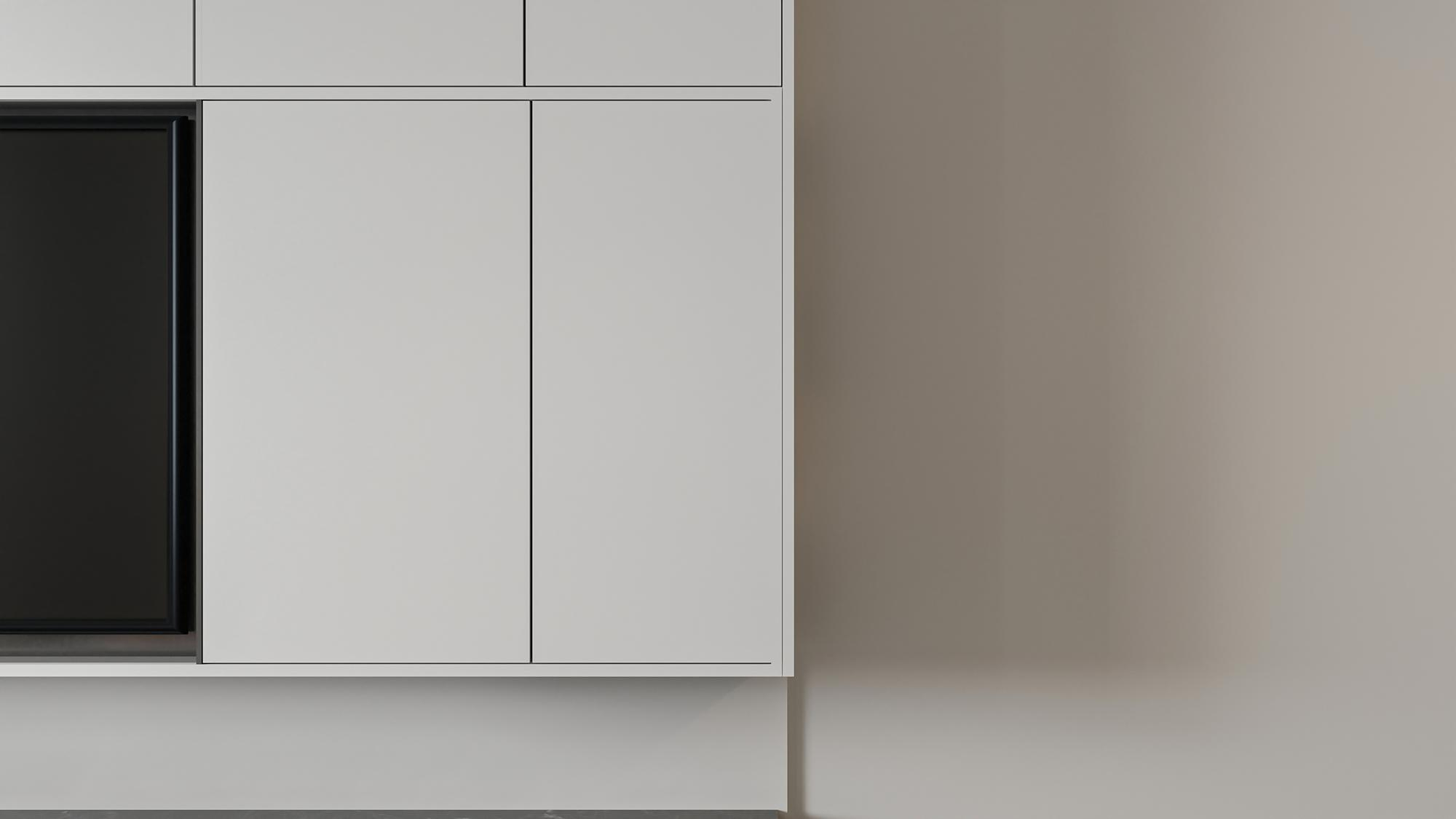 Soft gray wall with minimalist white kitchen cabinetry