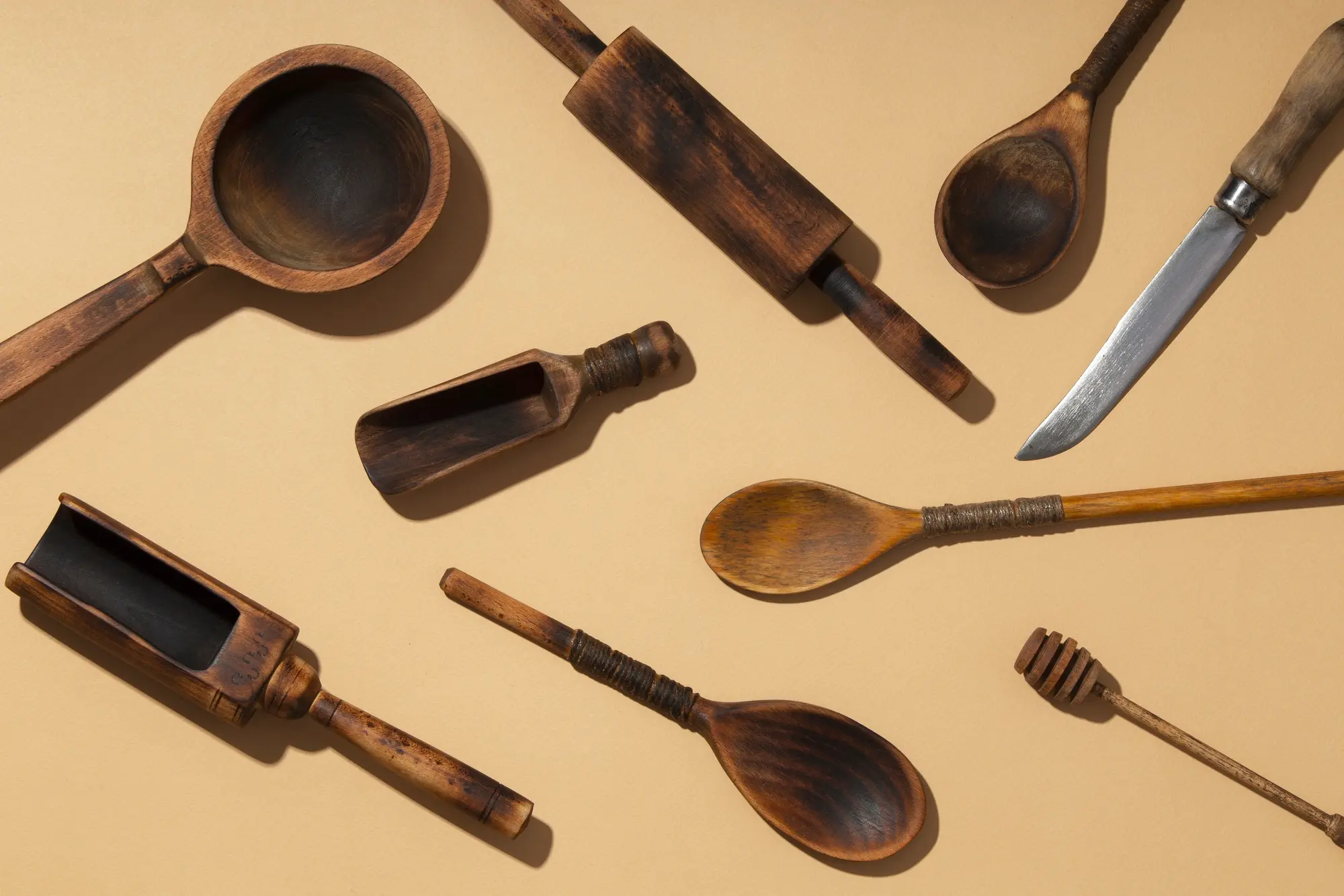 Teak wooden utensils set with vintage cooking tools layout