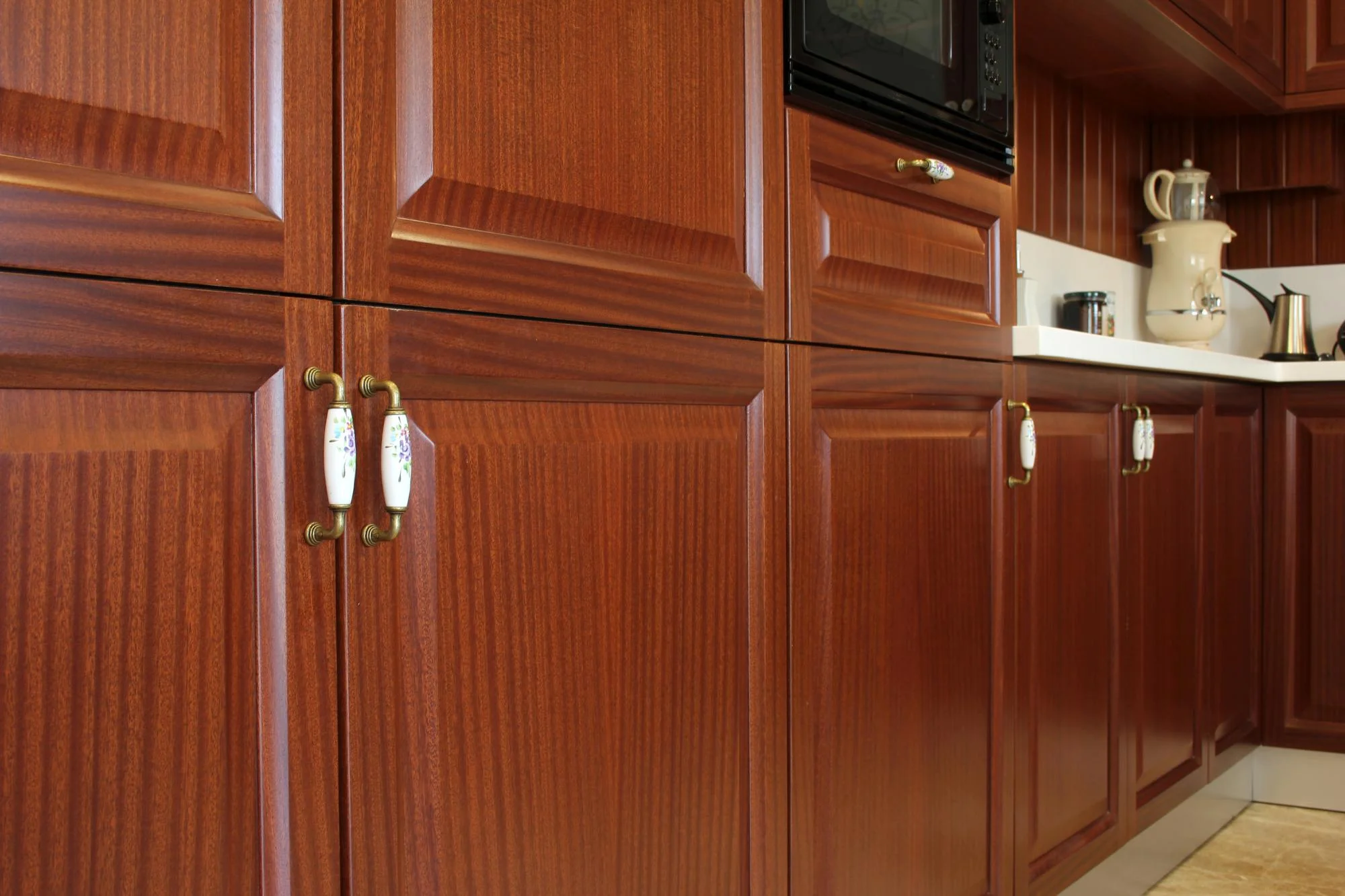 Warm stained wood kitchen cabinets with classic style