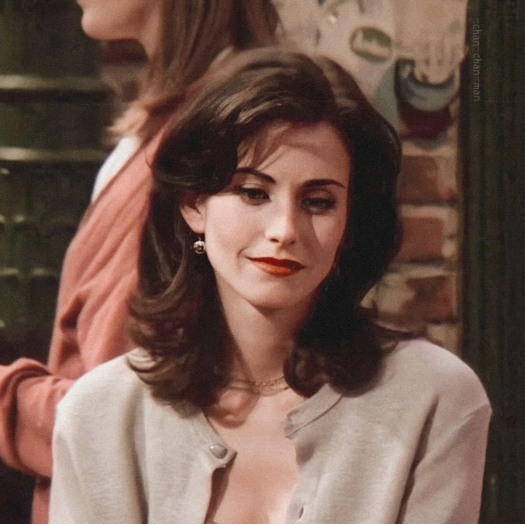 Woman with brown hair in cardigan