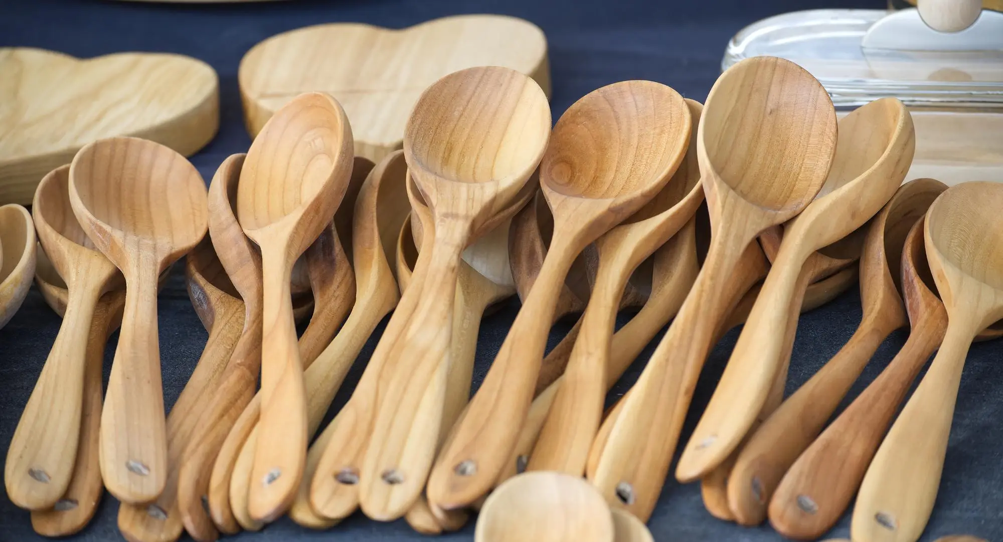 Wooden kitchen spoons set on dark background display