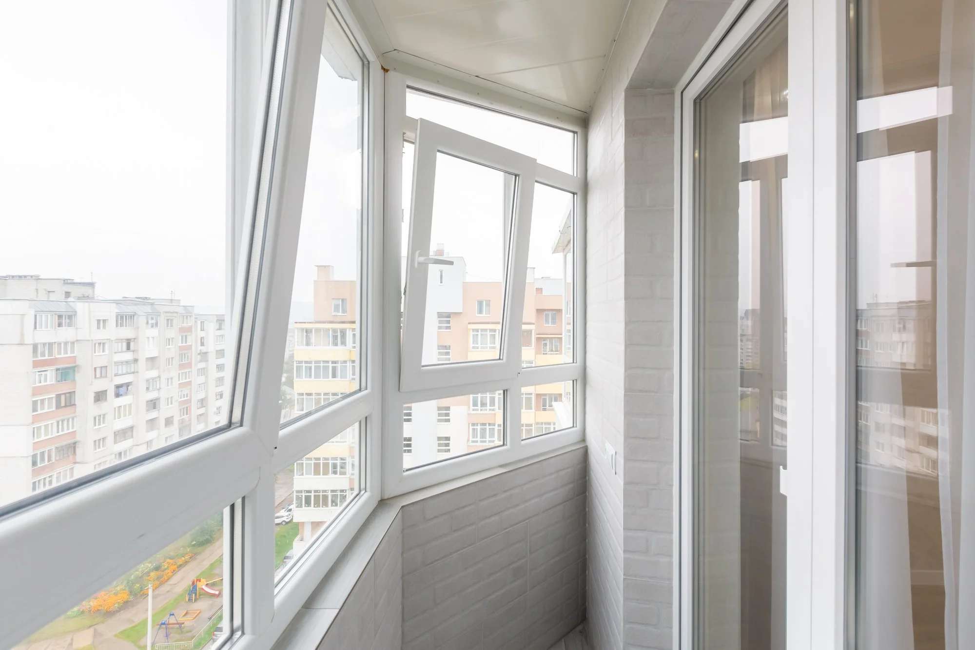 Modern balcony windows with white vinyl window frames