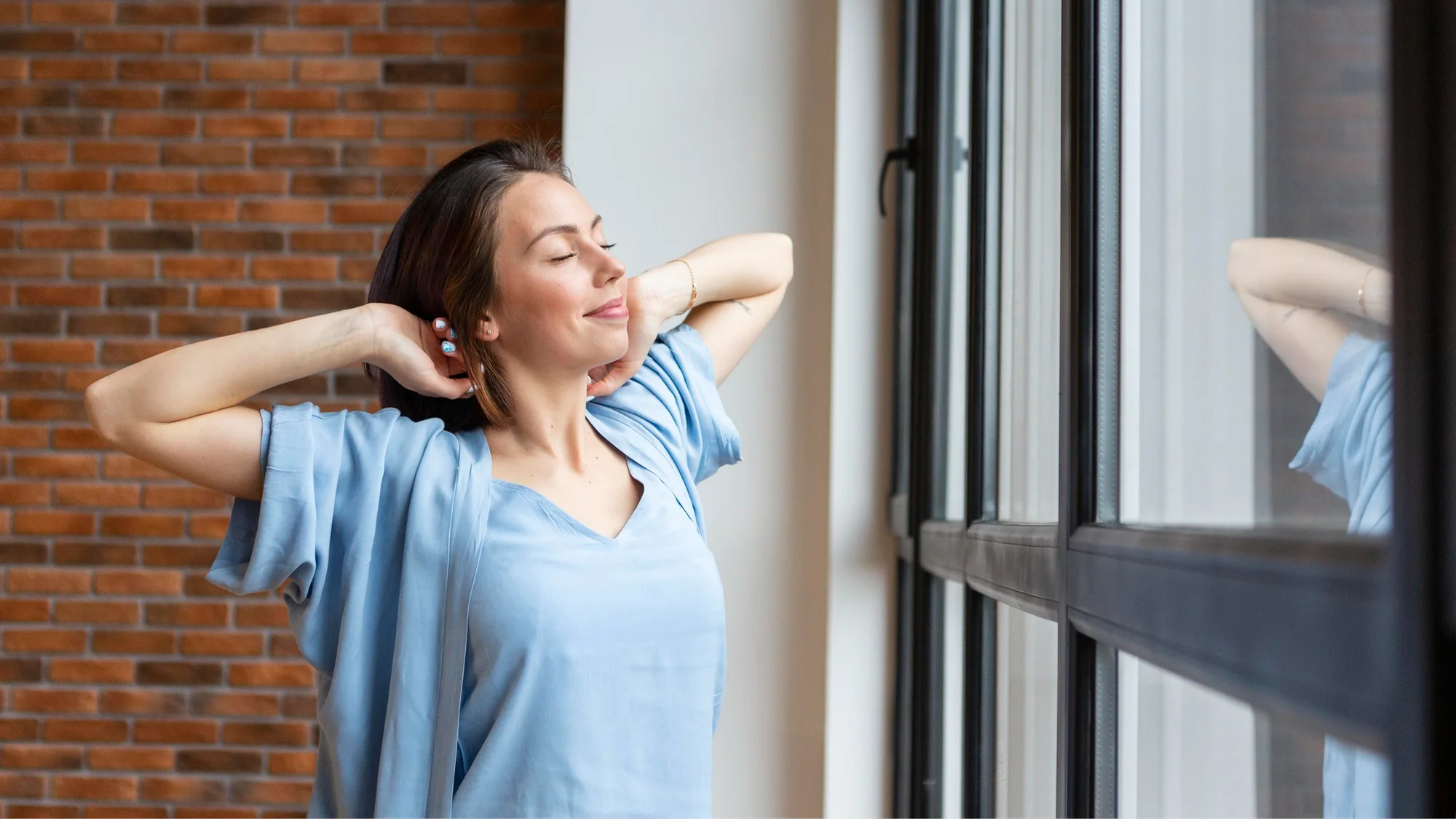 Woman enjoying fresh air near modern ventilation window
