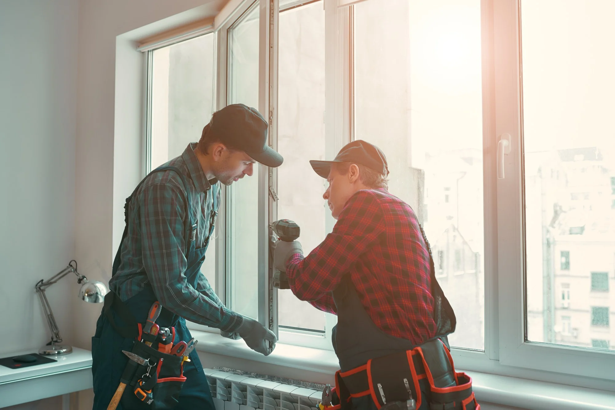 Workers installing residential energy efficient windows